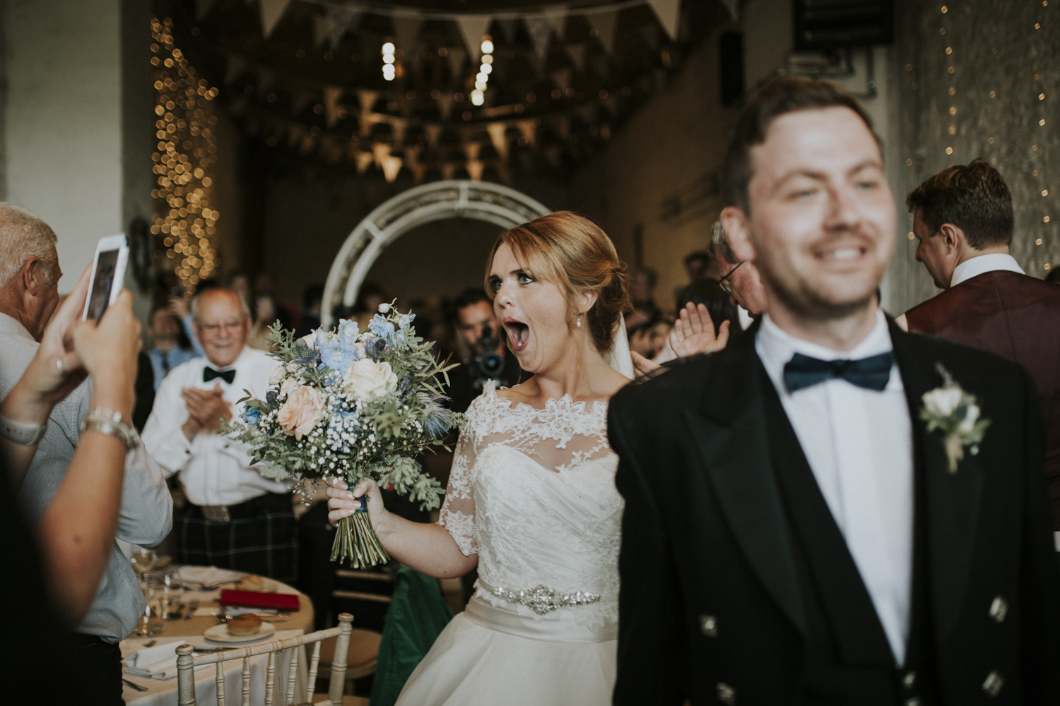 bride and groom walk in reception