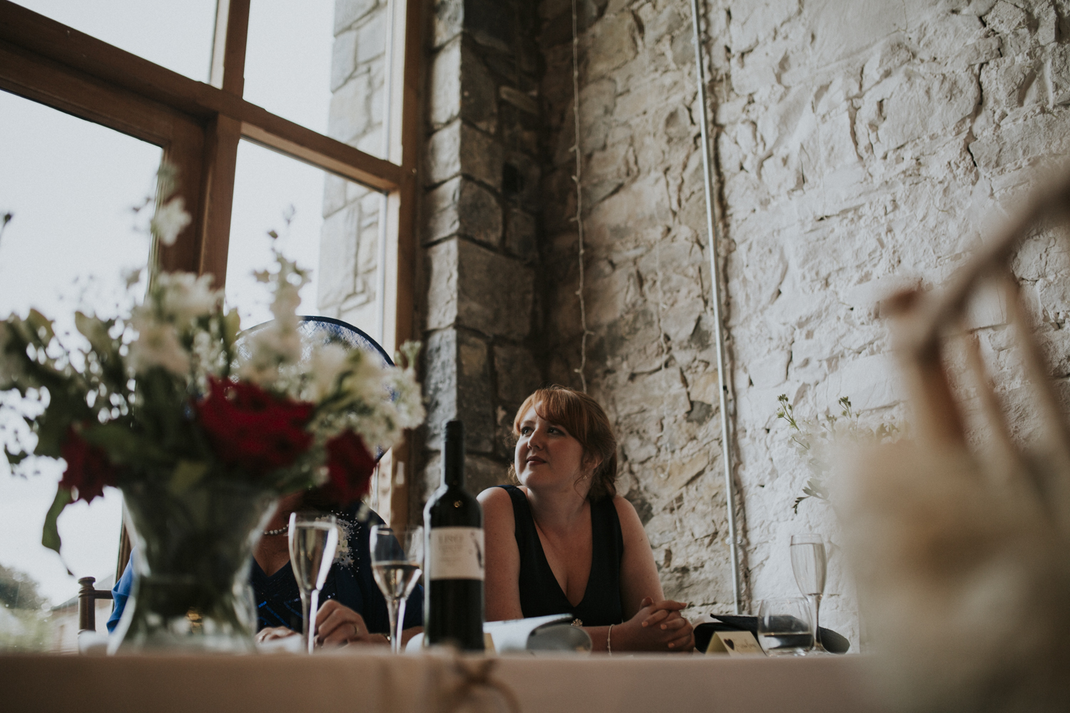 sister smiling at wedding speech