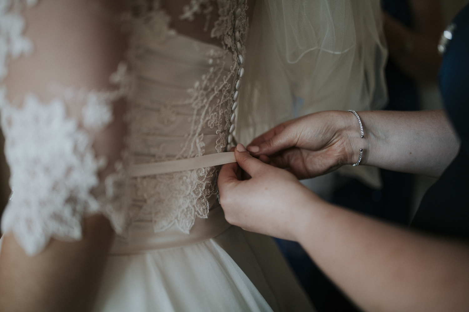 bride doing up dress