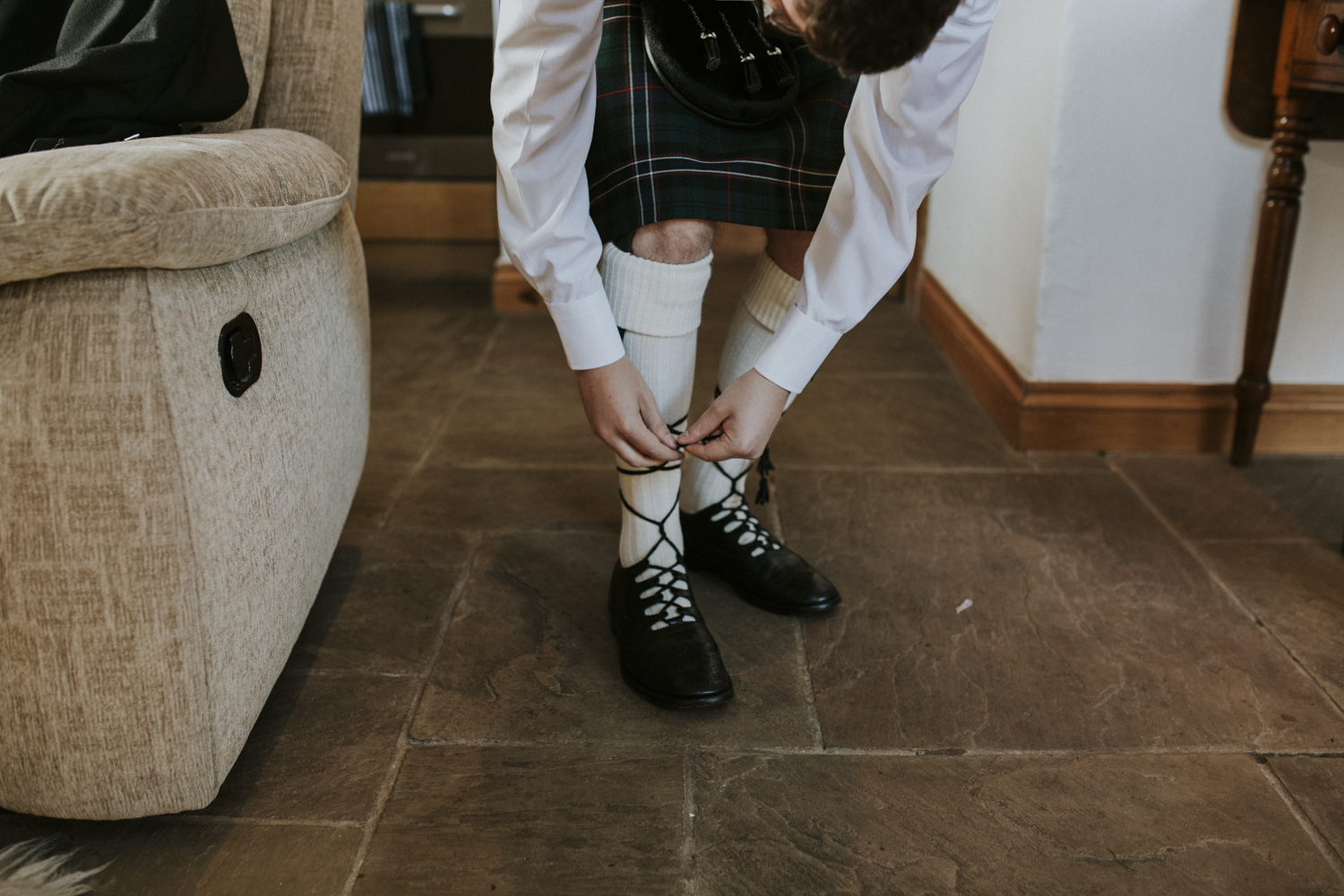 groom doing up his shoes