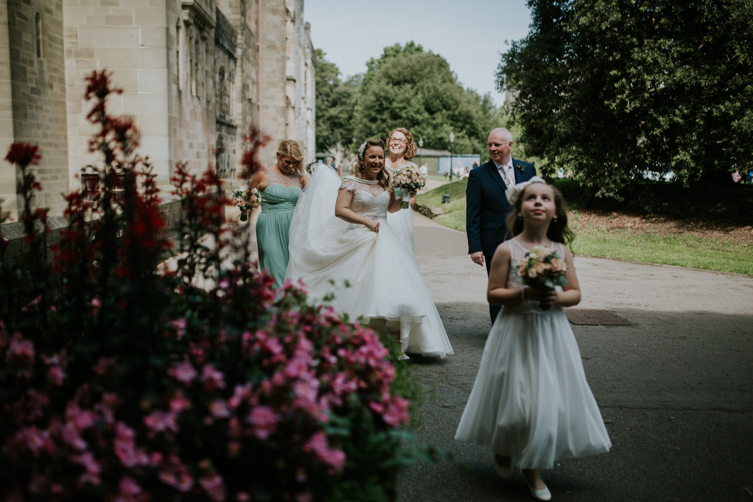 bride and bridesmaids walking towards ceremony