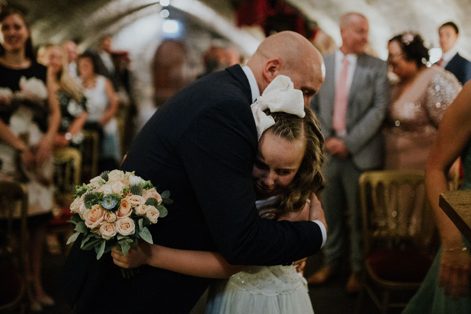 flower girl hugging groom