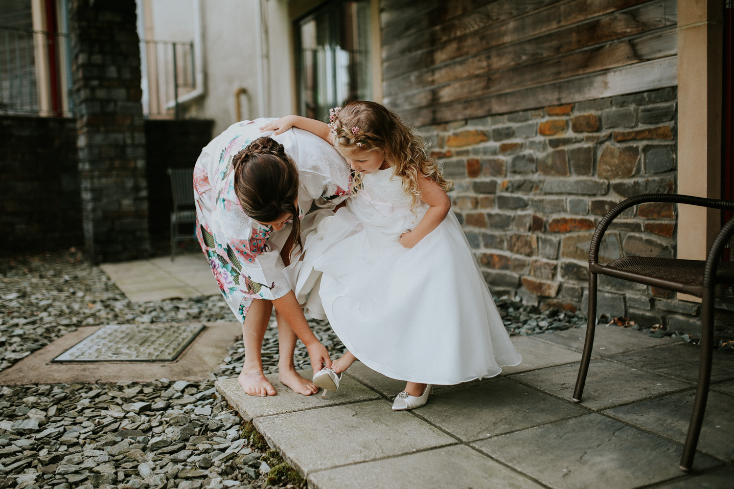 little girl trying on brides shoes