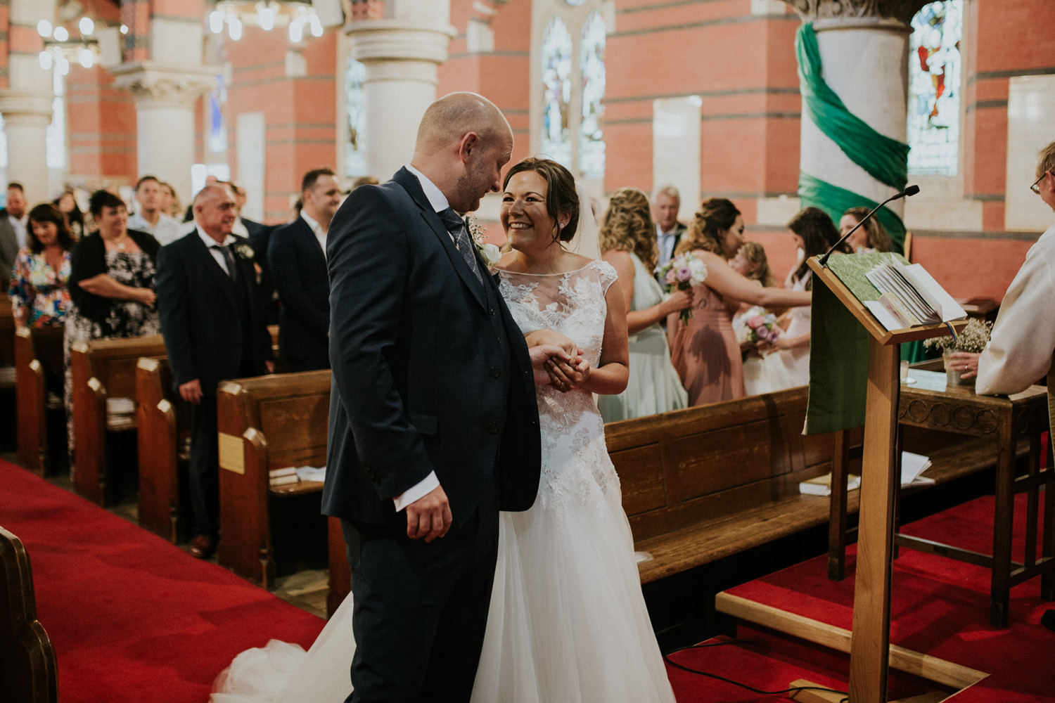 bride and groom smiling in the ceremony