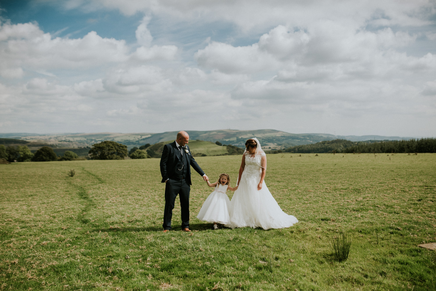 bride, groom and daughter family portrait