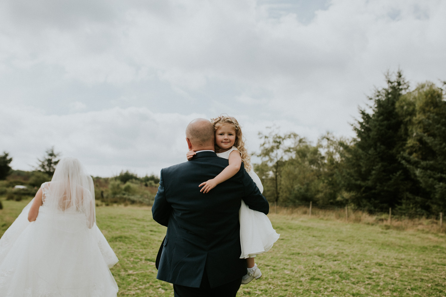 dad carrying daughter