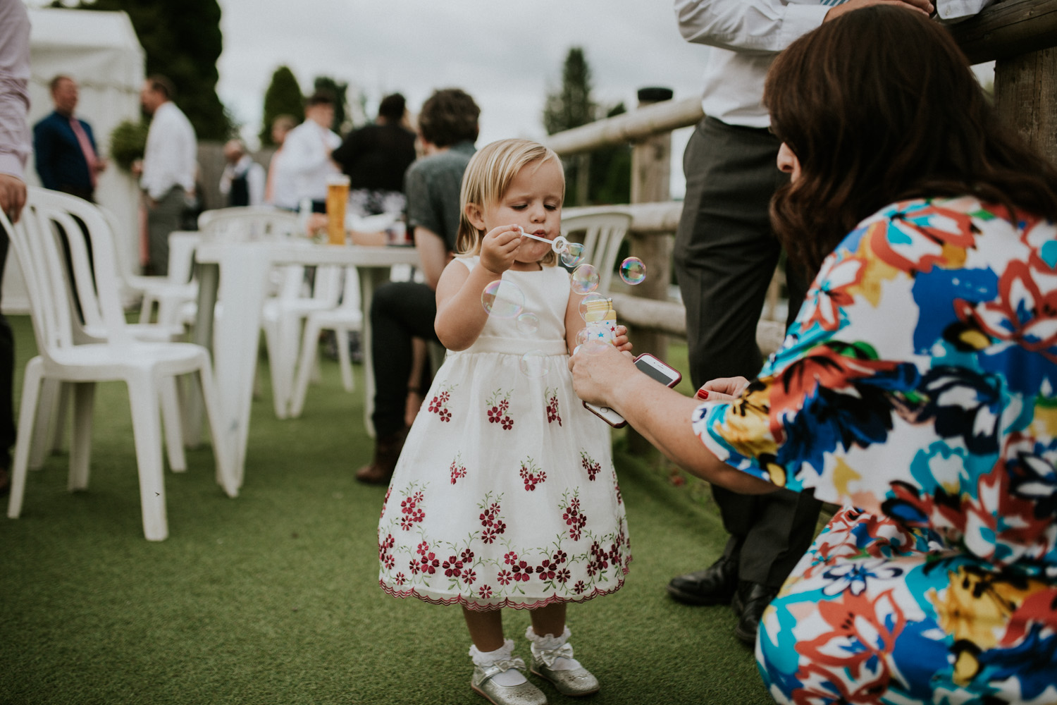 little girl blowing bubbles