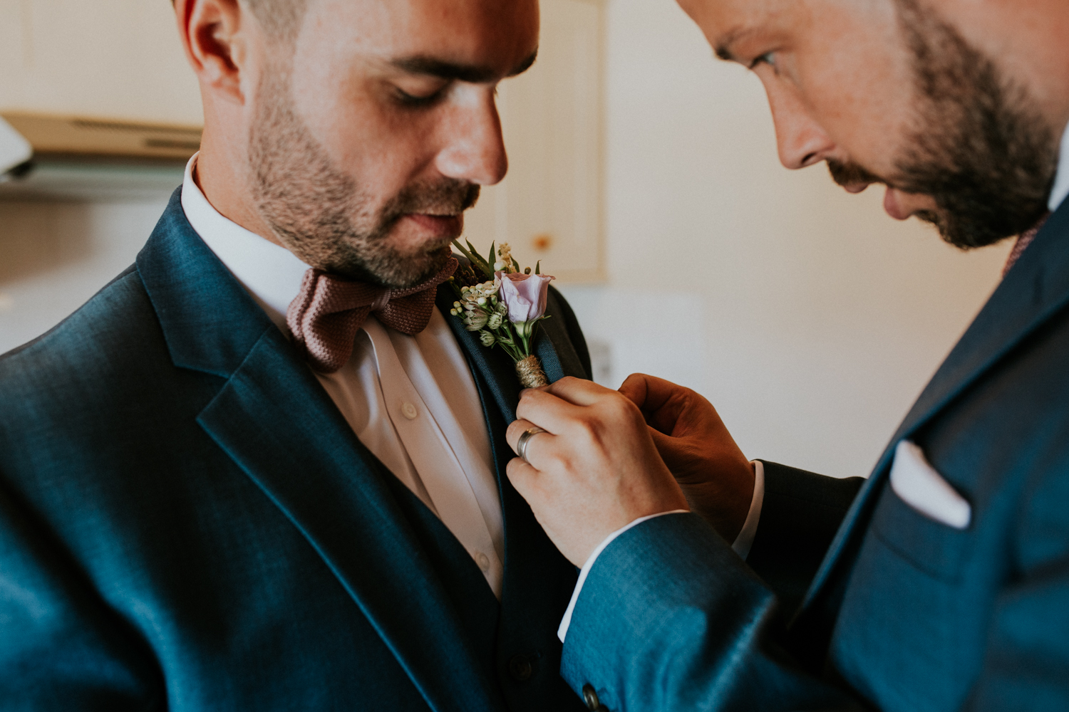 groom putting on his flower