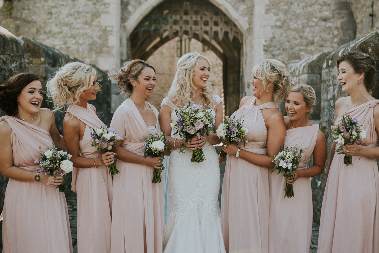 bride and bridesmaids laughing