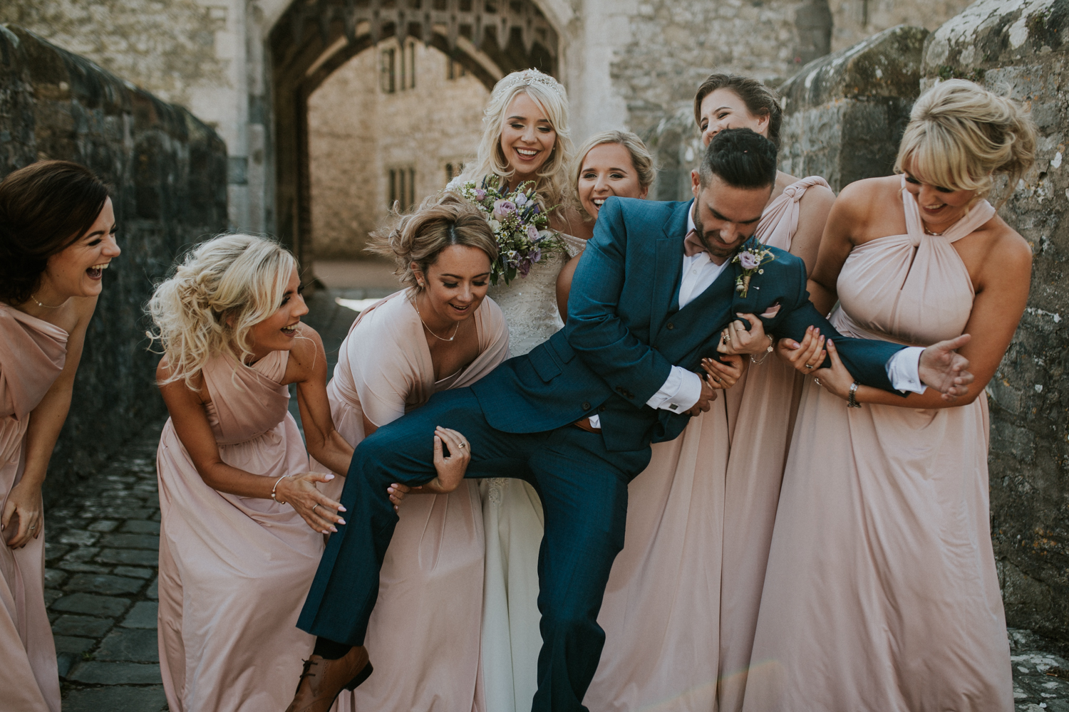 bridesmaids lifting the groom