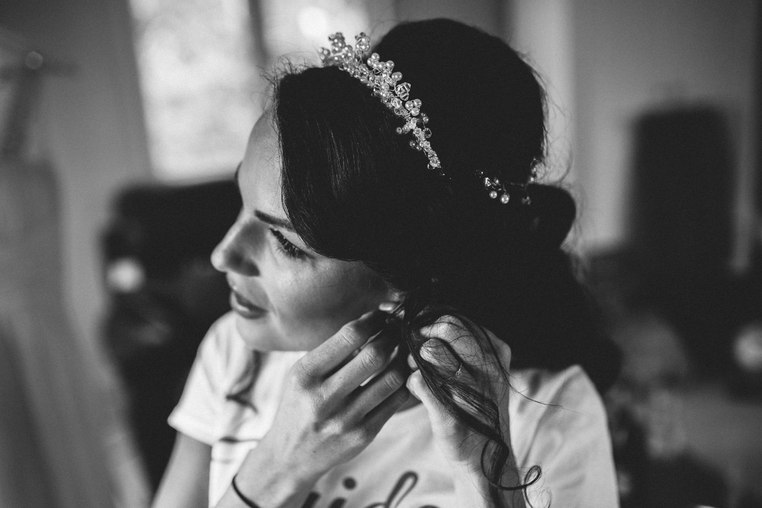 bride putting earring in