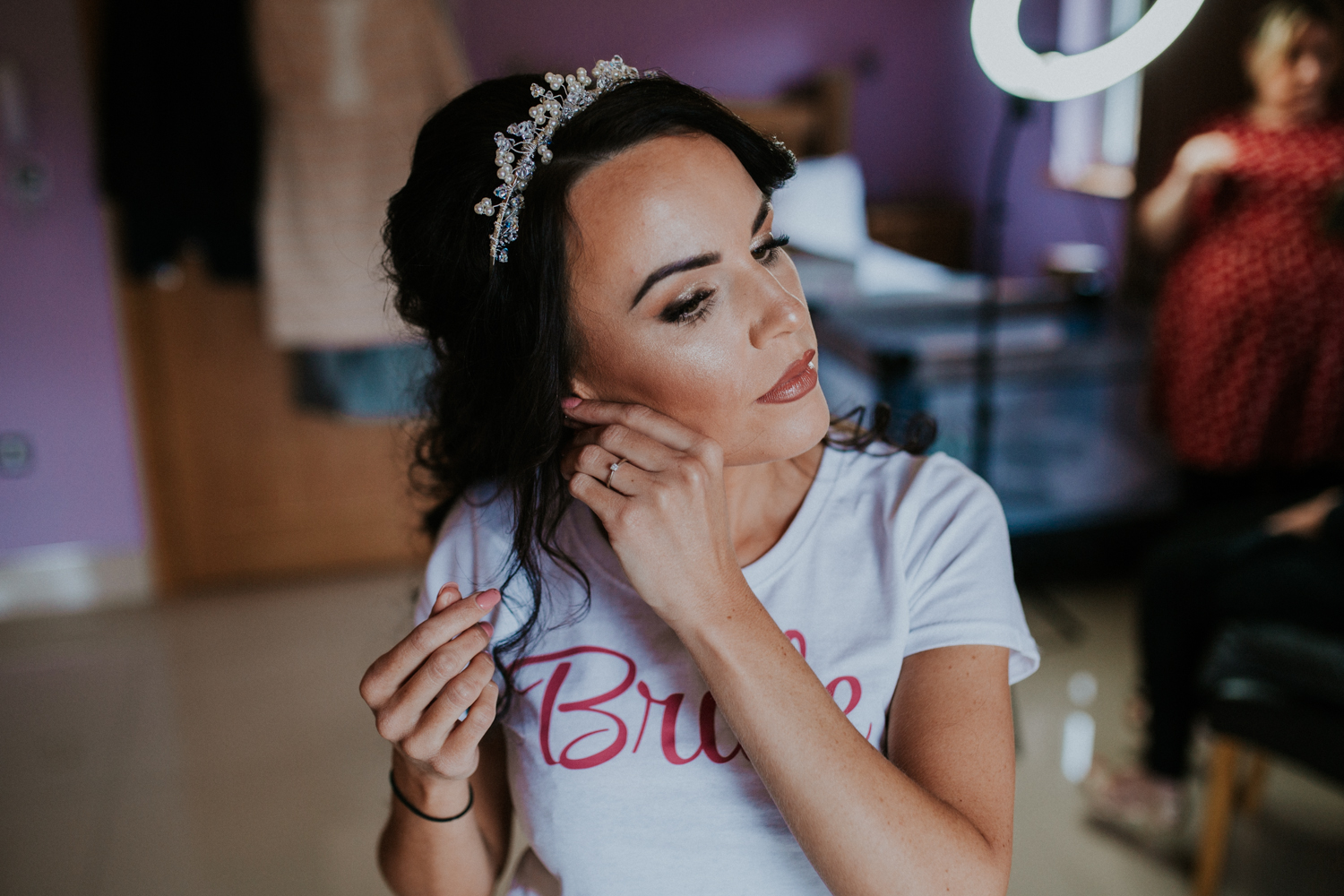 bride putting jewellery on