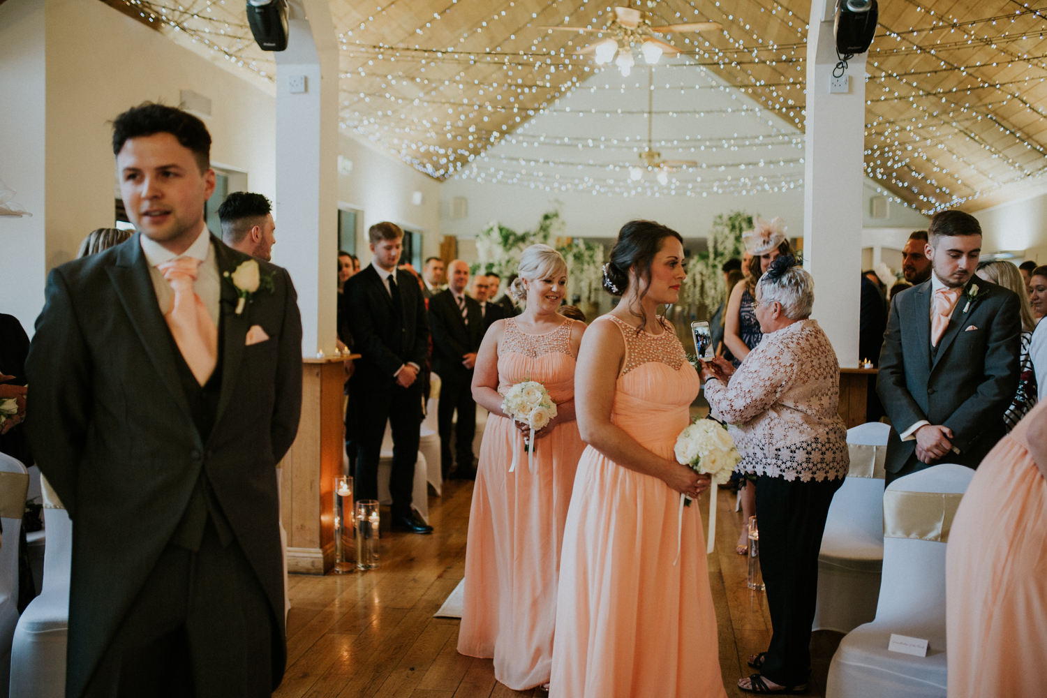 bridesmaids walking down the isle 