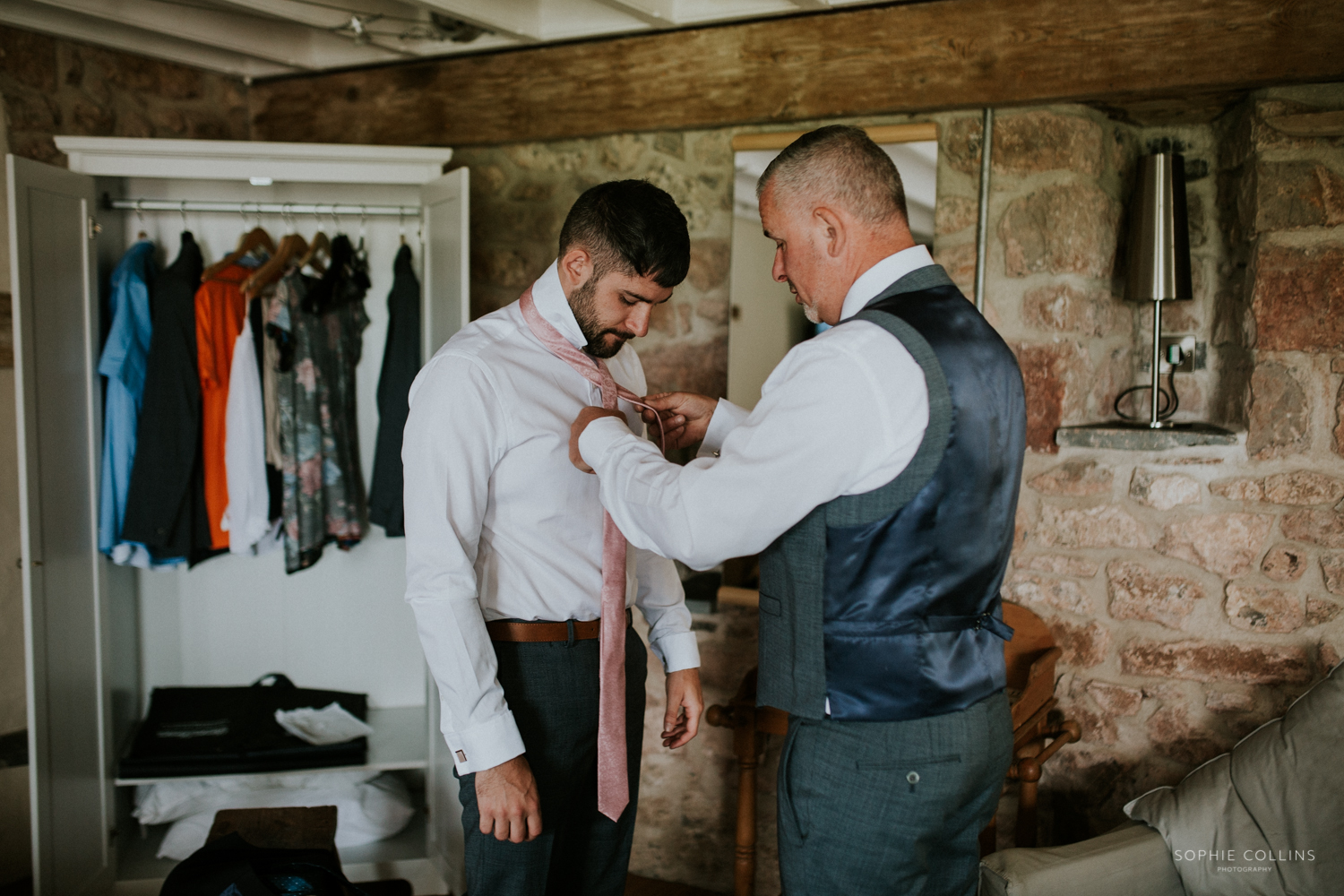 groom doing his tie