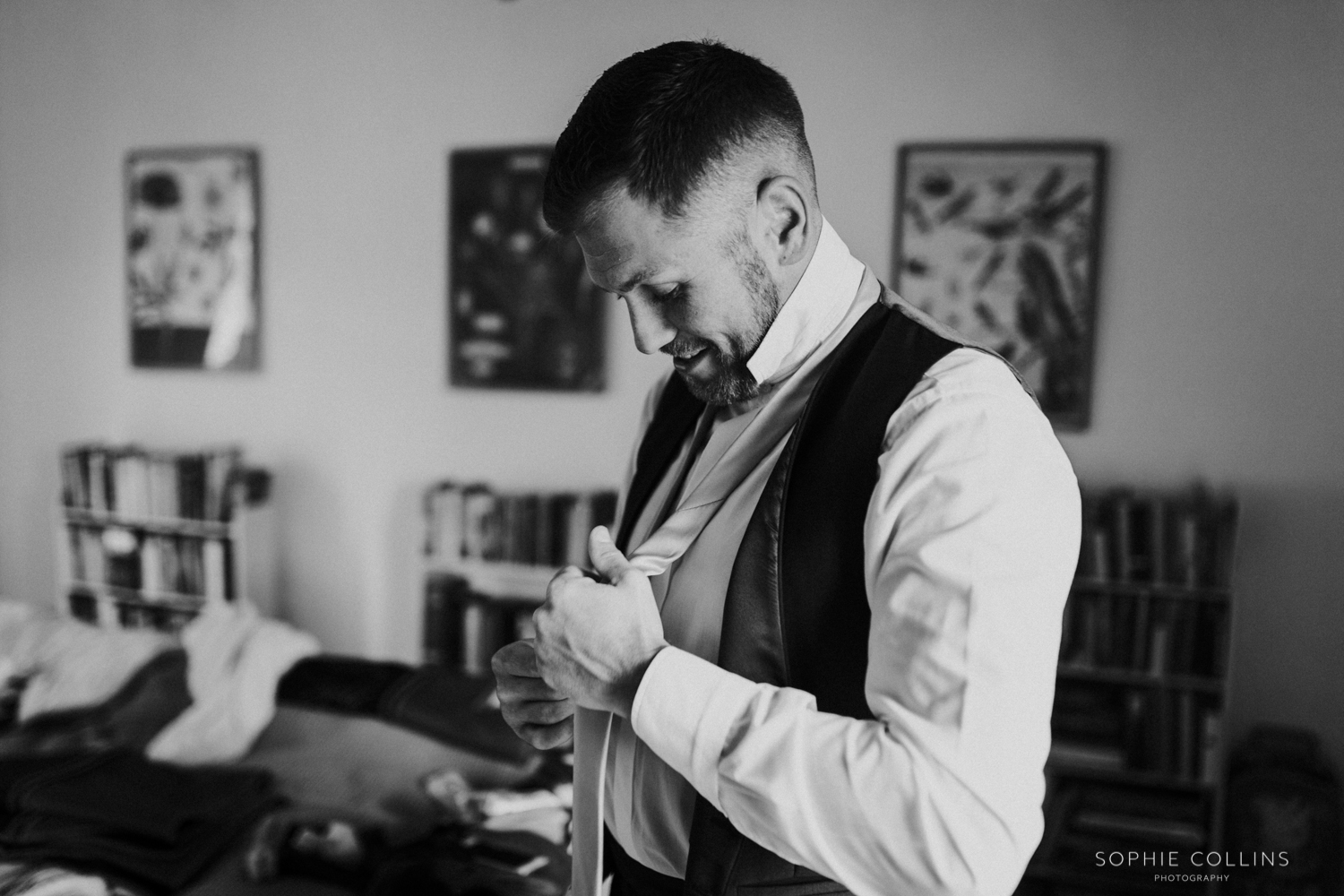 groom doing his tie