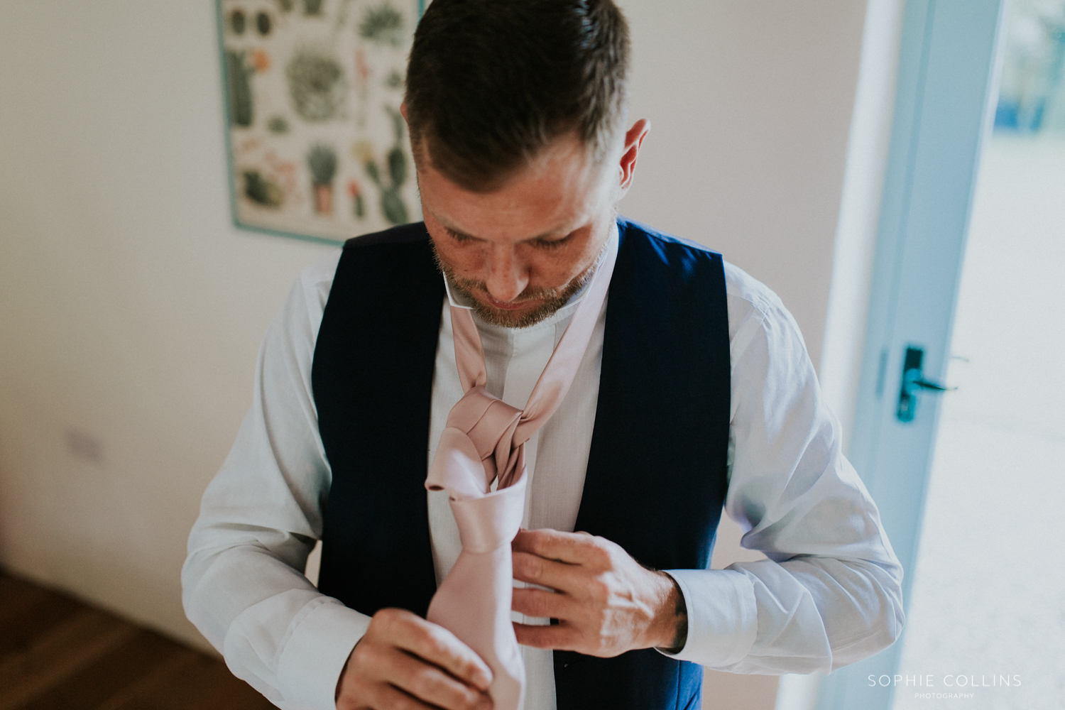 groom doing his tie 