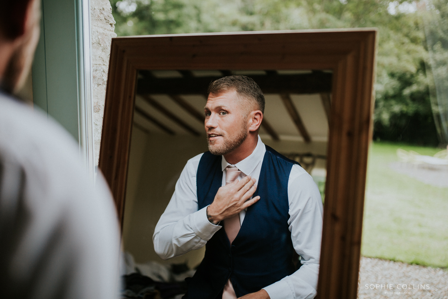 groom doing his tie