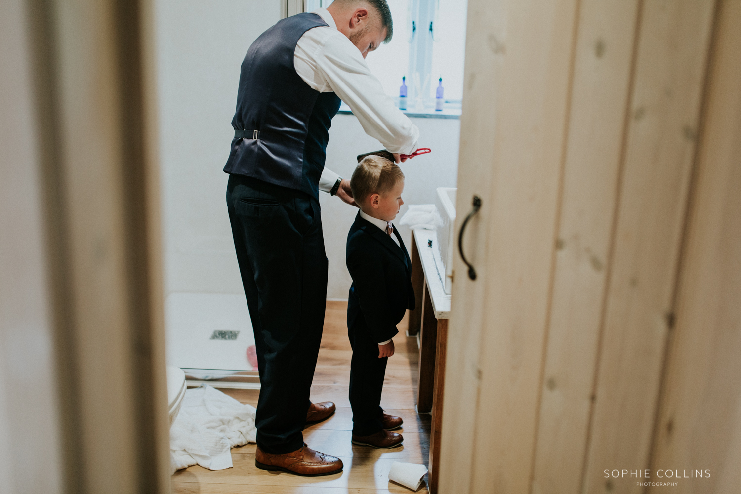 groom doing little boys hair