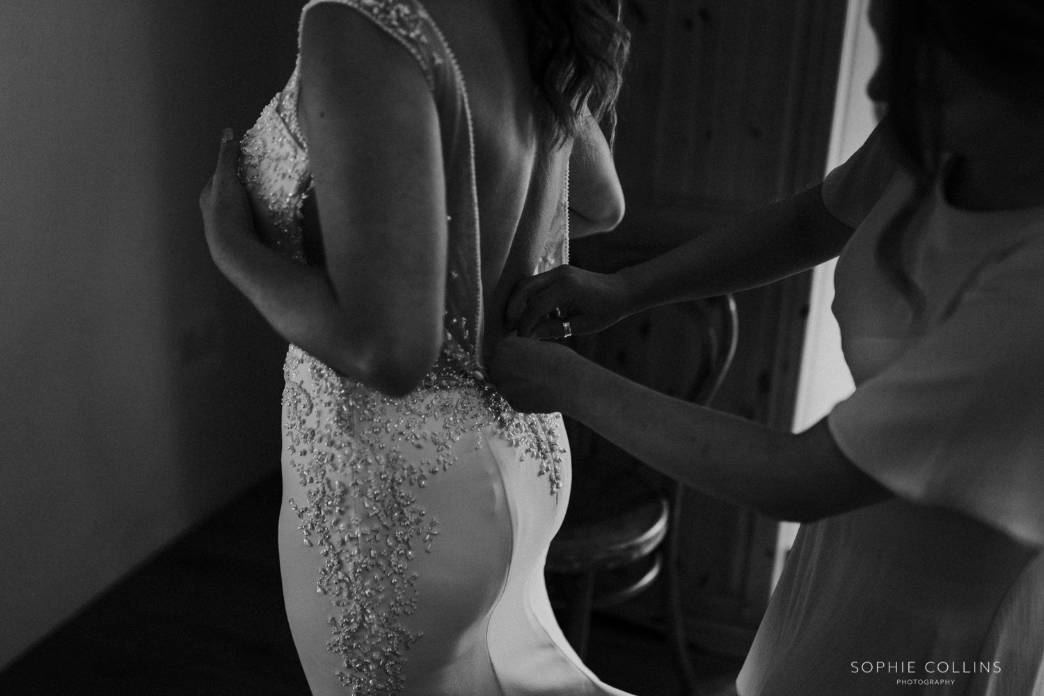bride putting her dress on