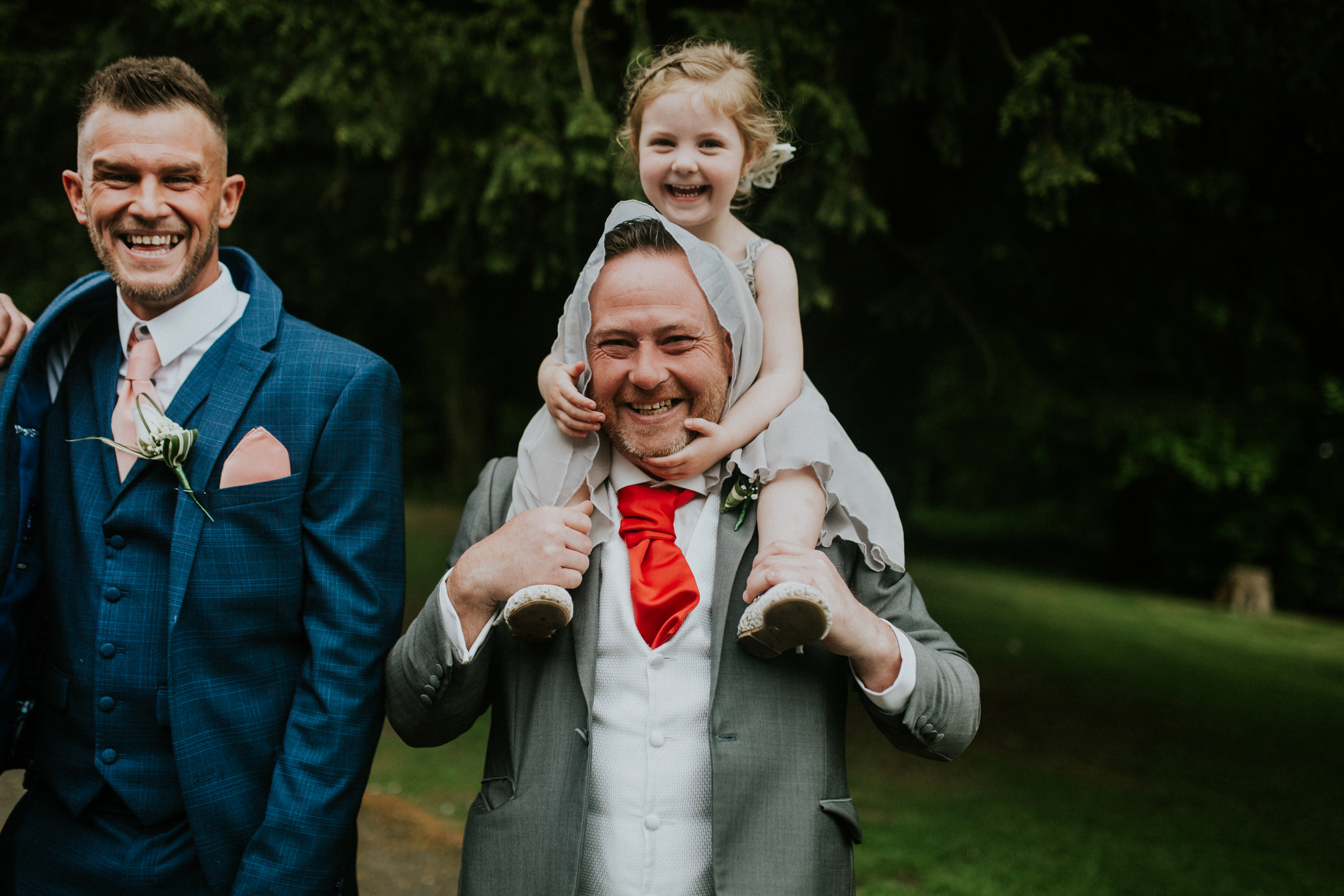 man with girl on shoulders