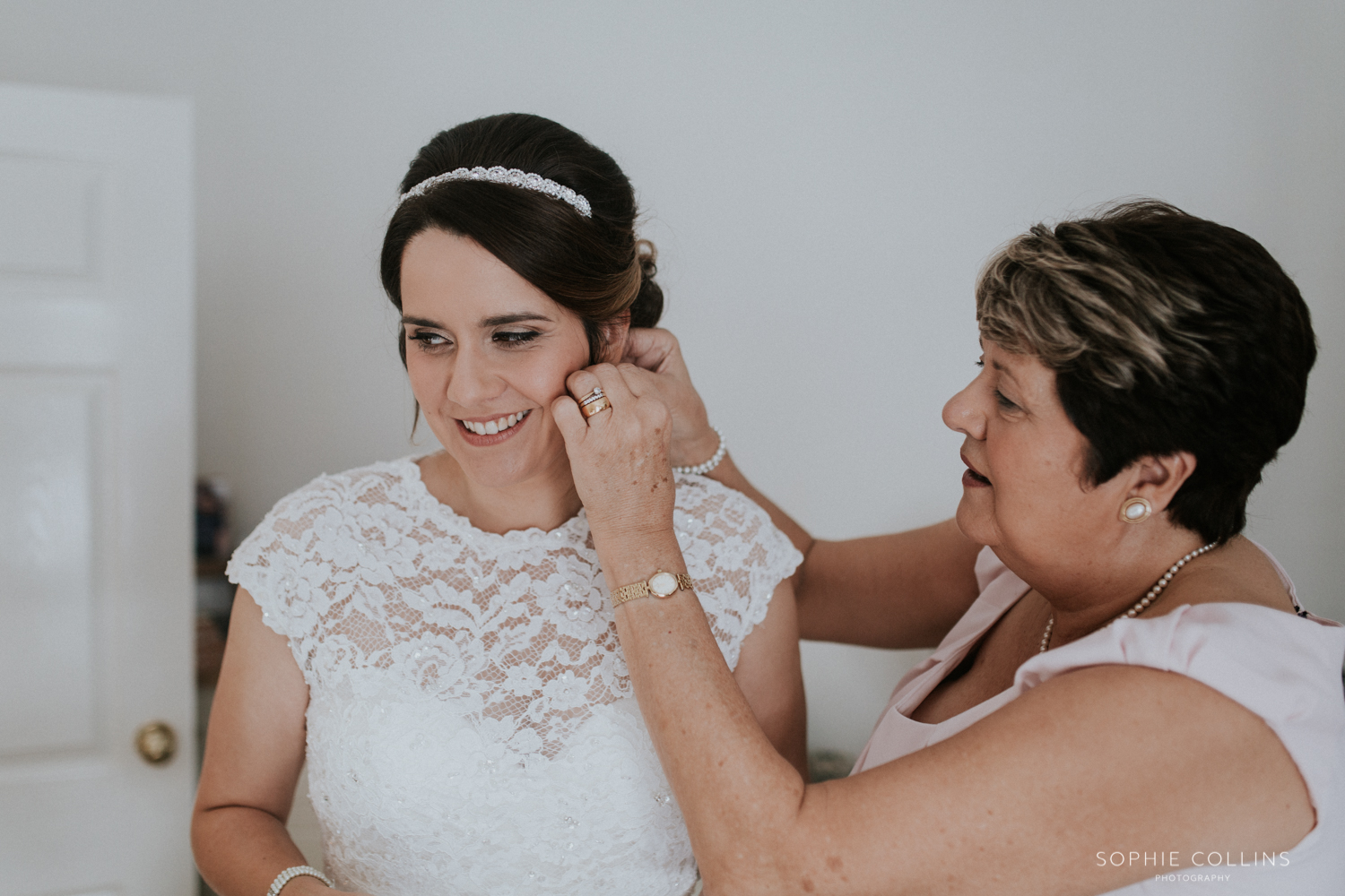 mother doing brides earrings 