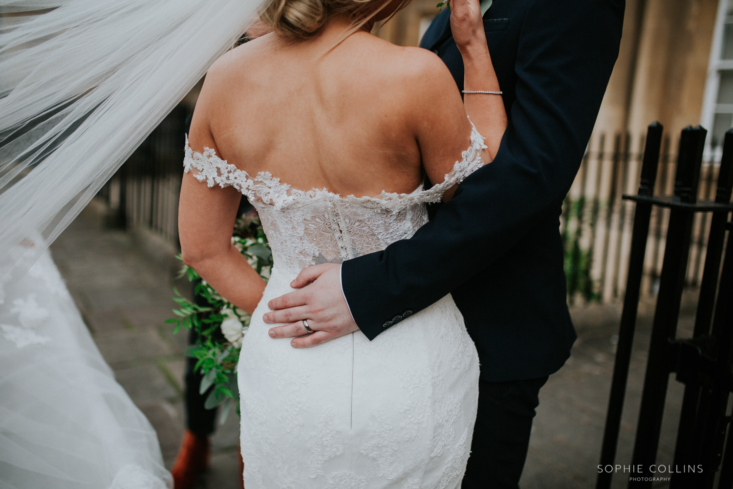 grooms hand around the bride