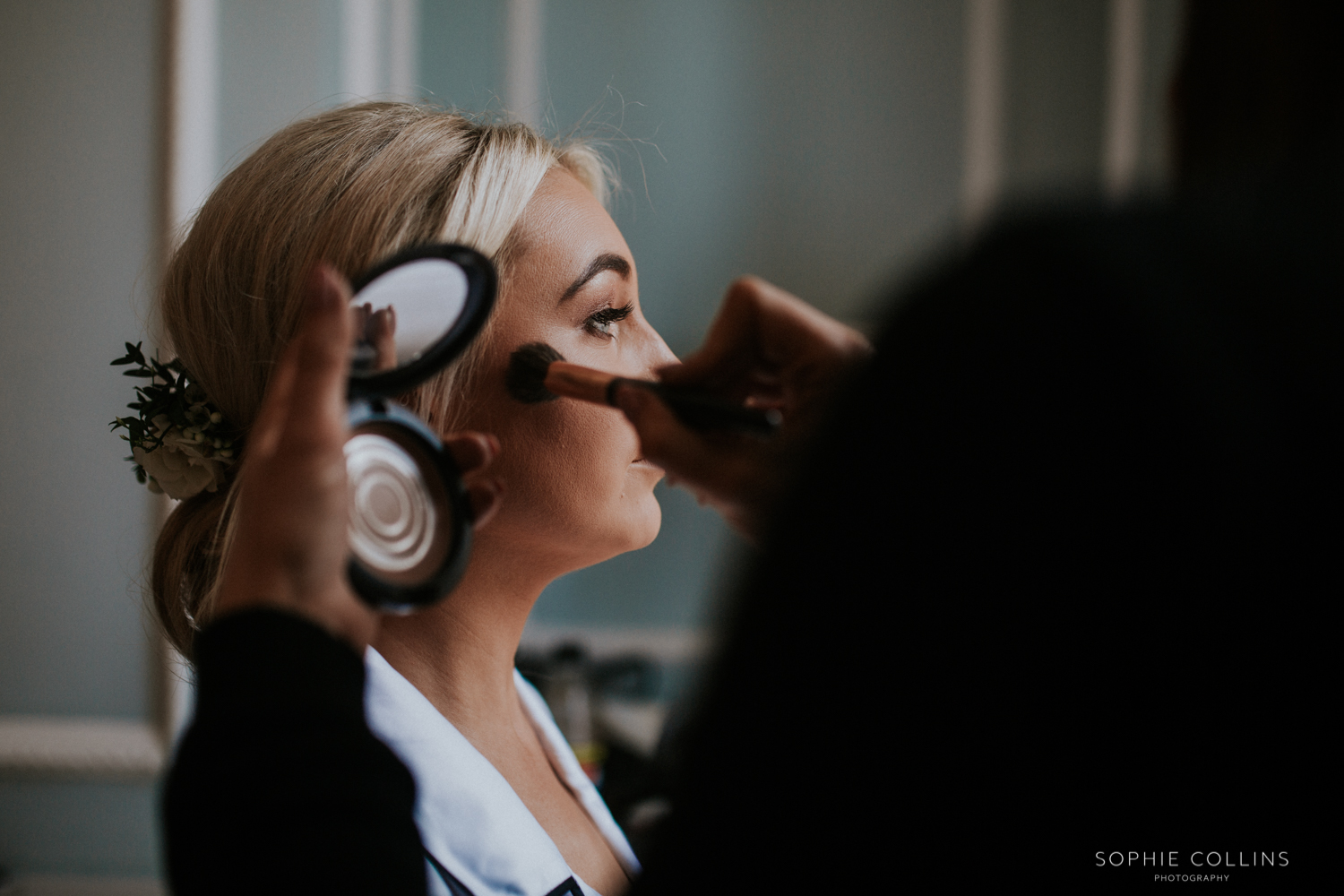 bride having her makeup done