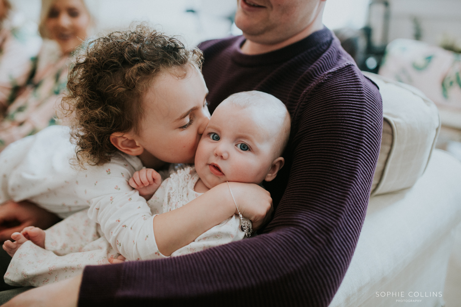 little girl kissing baby