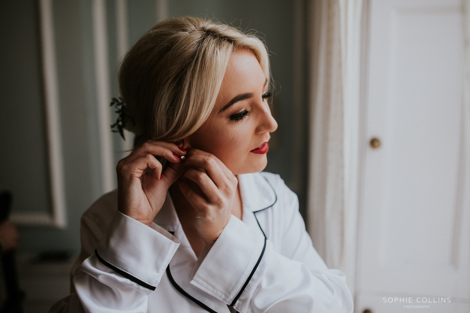 bride putting her earring in 