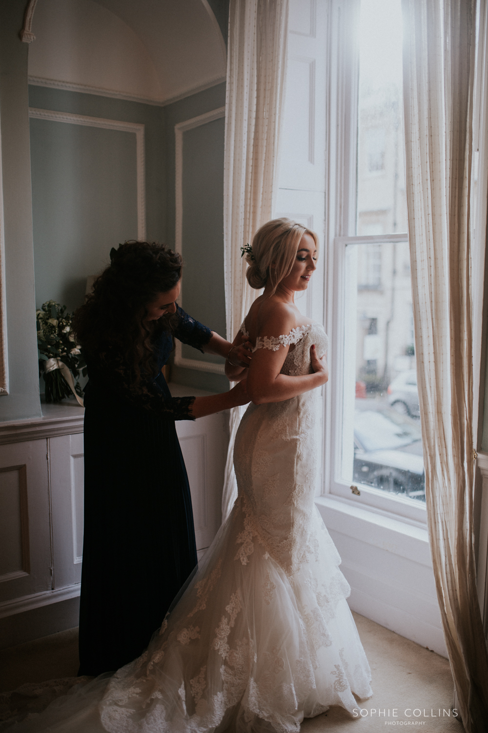 sister doing brides dress