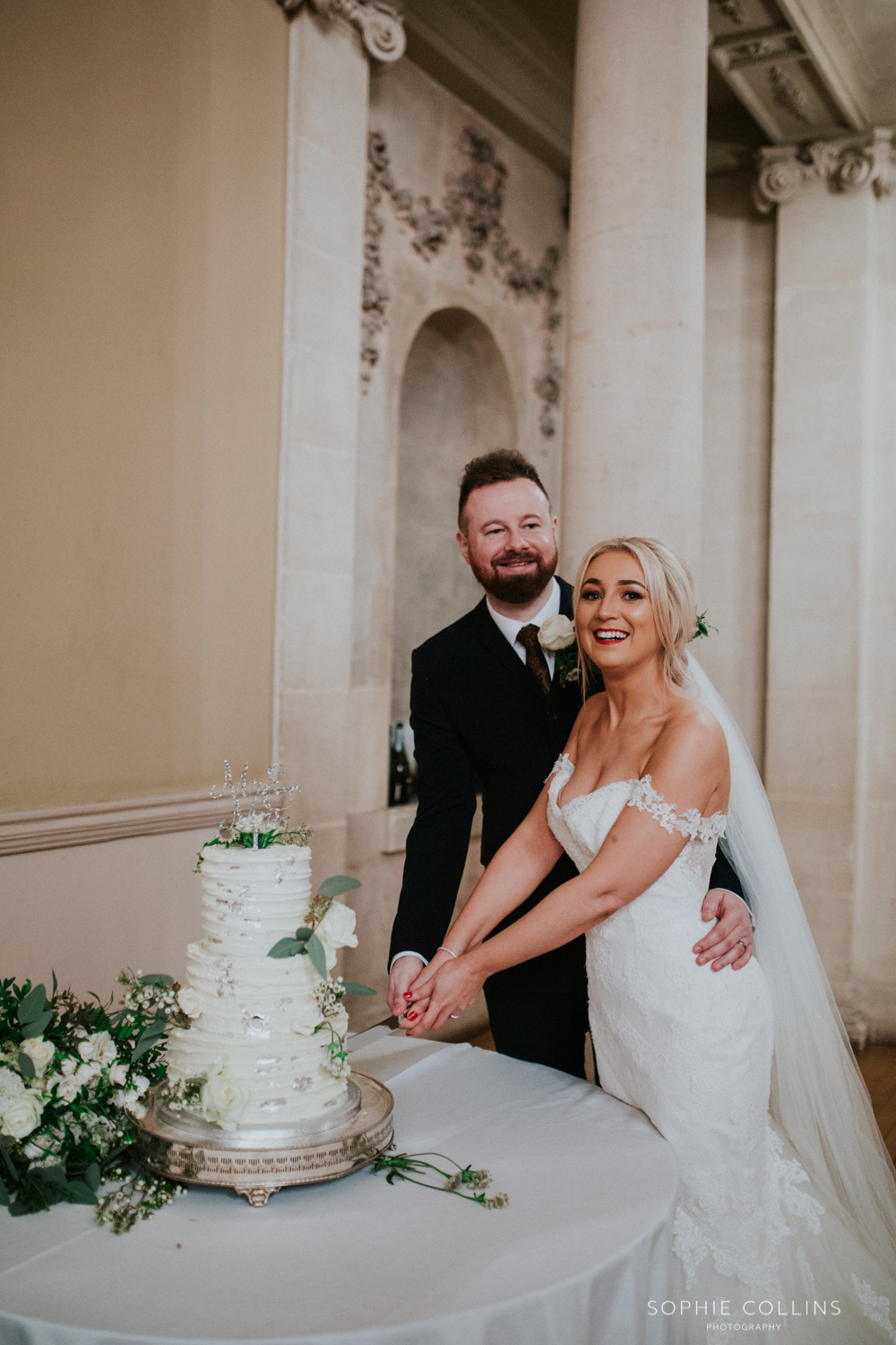 bride and groom cutting the cake