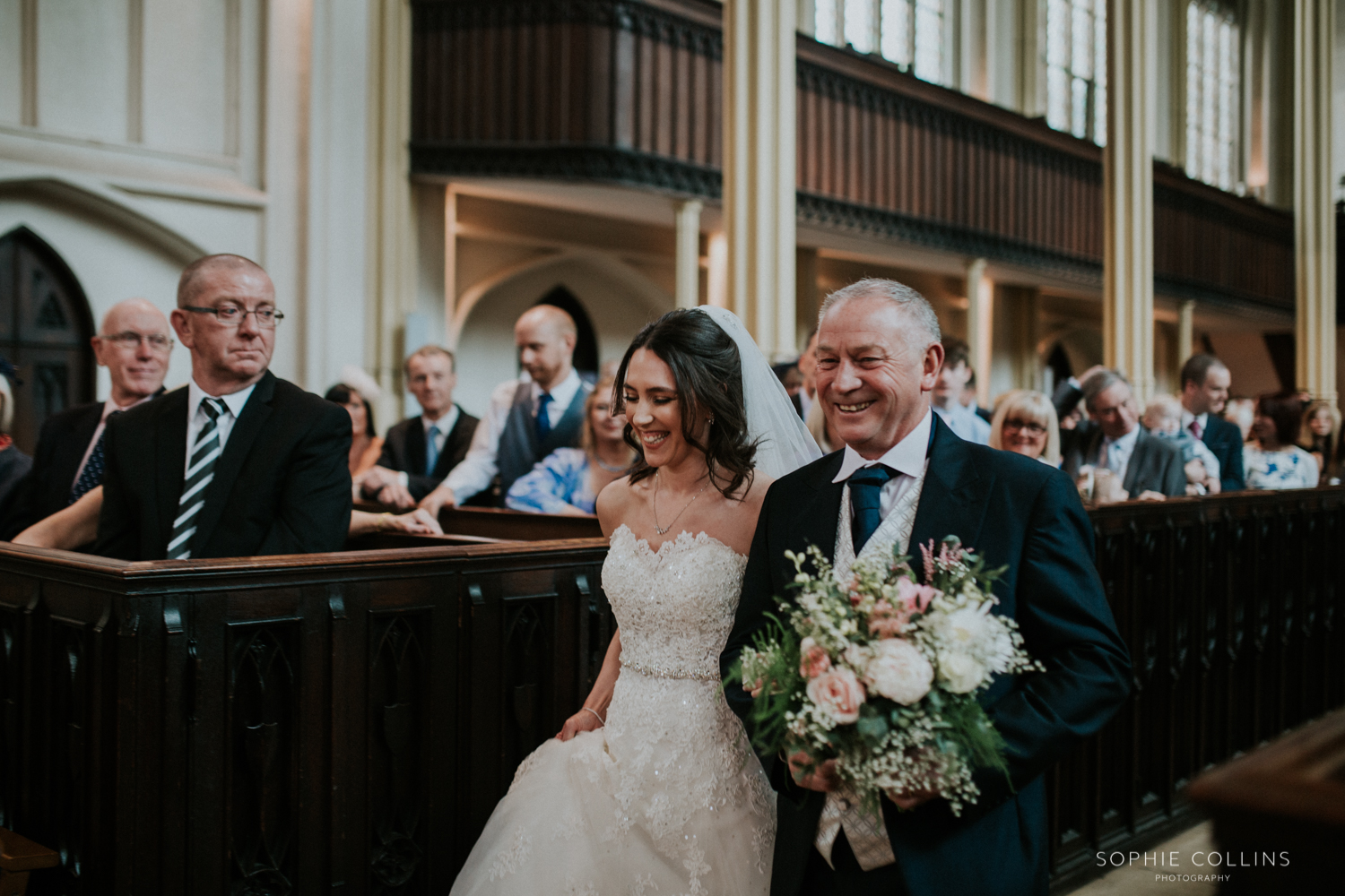 bride and dad walking down the isle 