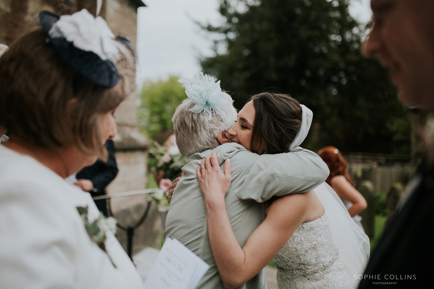guest hugging bride 