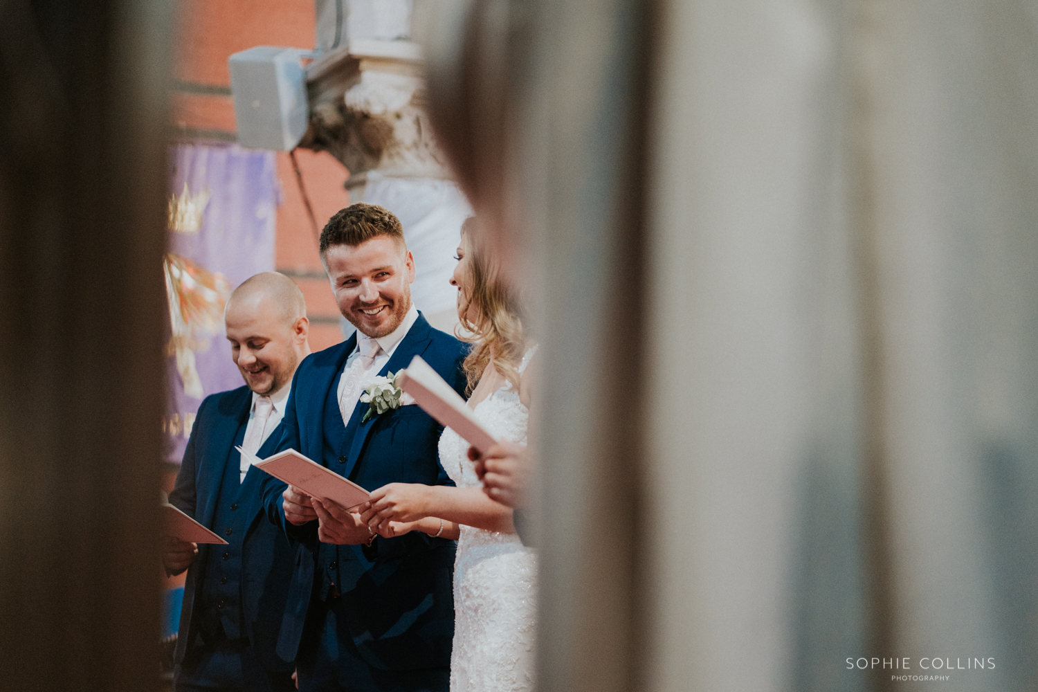 groom smiling at the bride in the church 