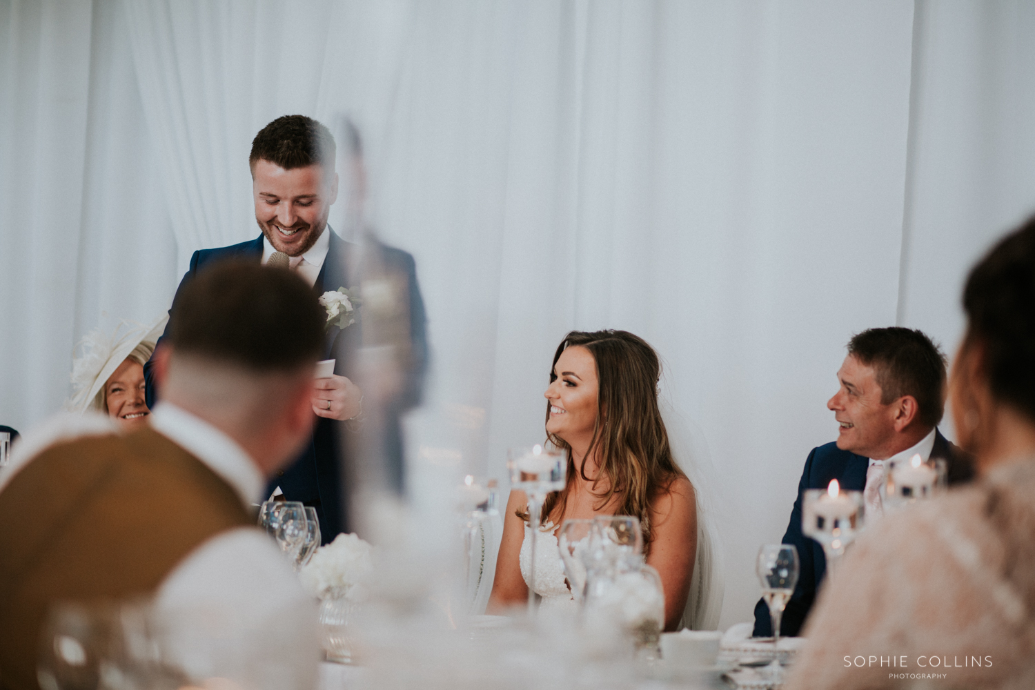 bride smiling, groom speech 