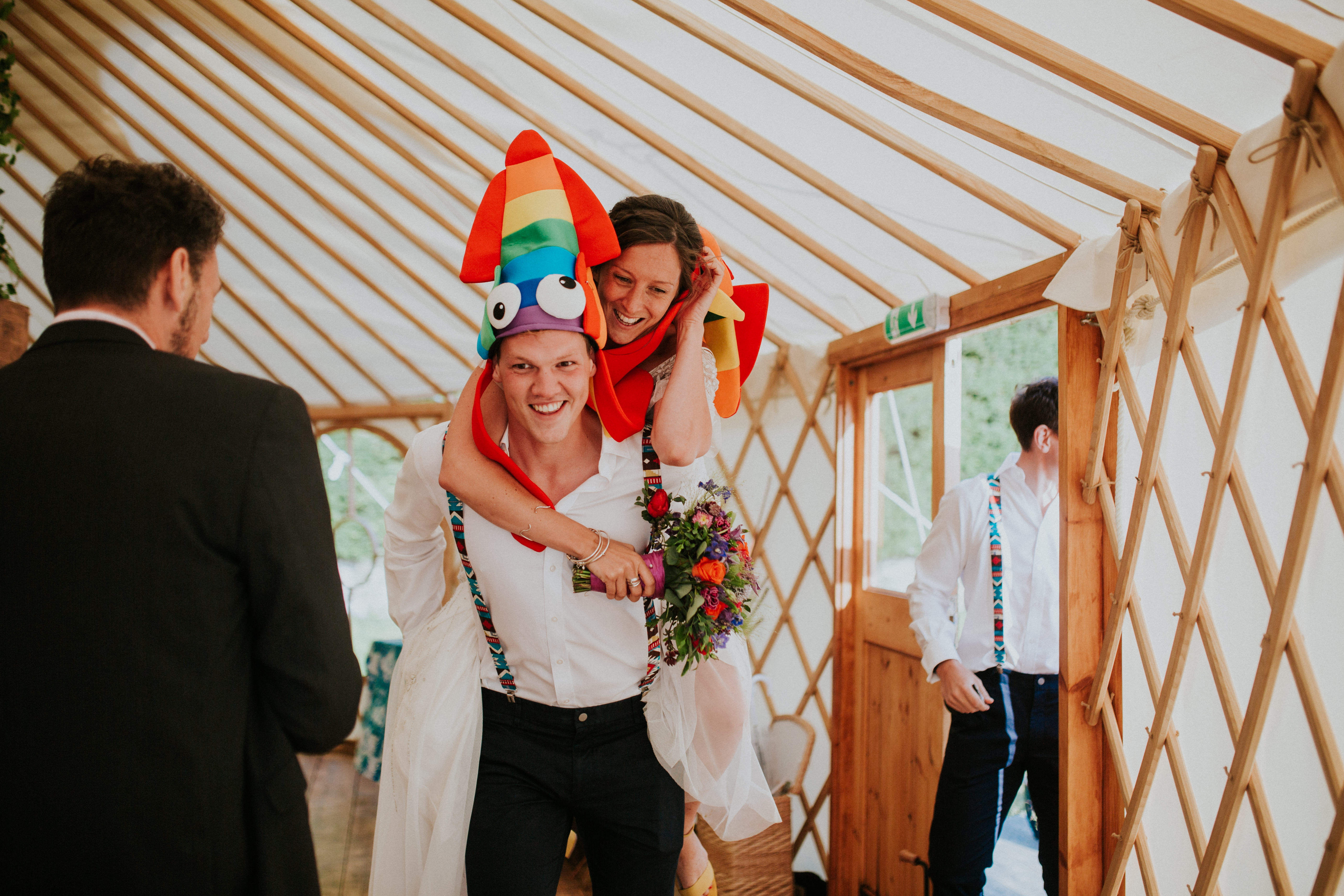 bride and groom wearing funny hats 