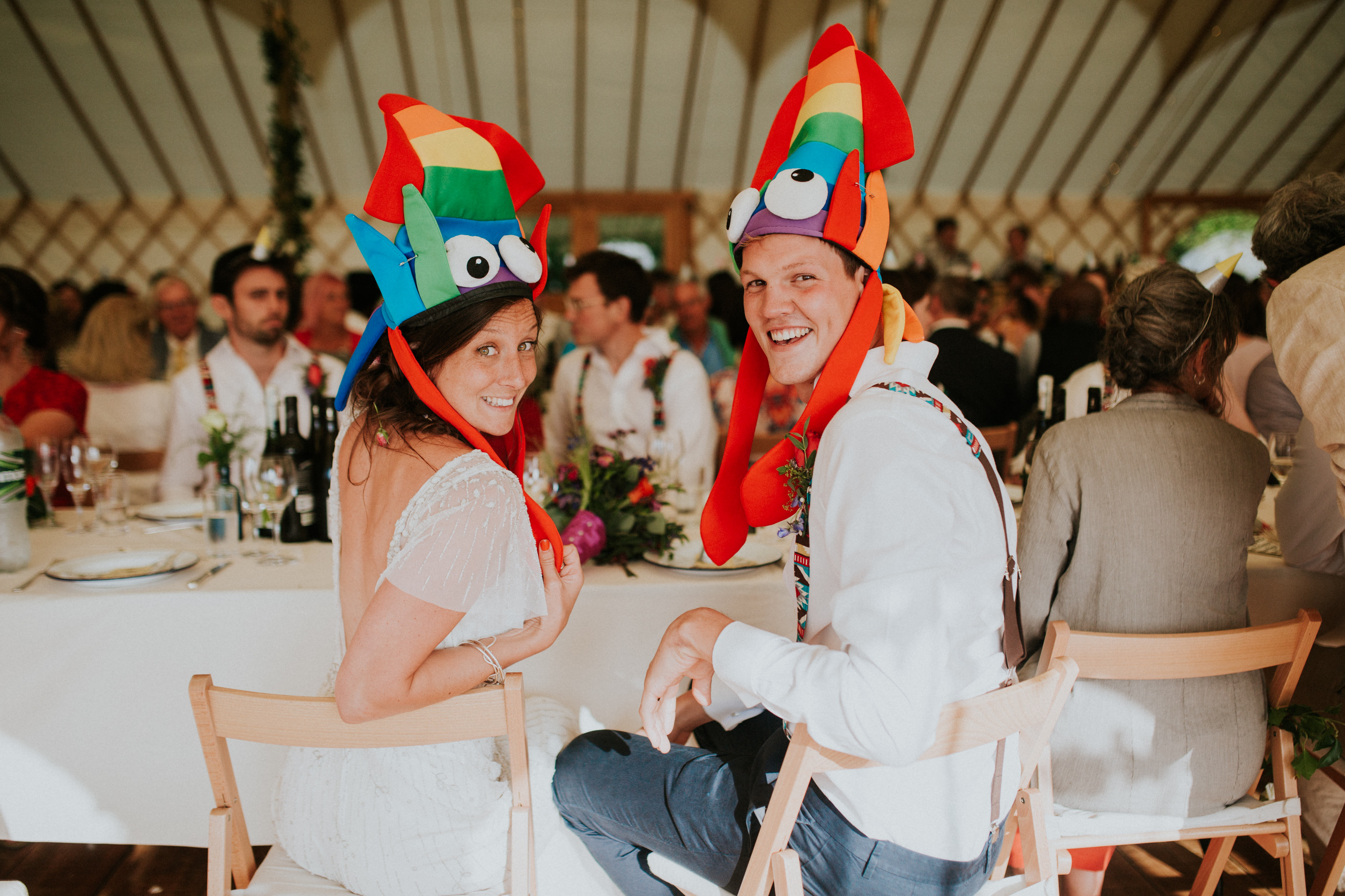 bride and groom wearing funny hats 