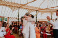 bride and father of the bride hugging