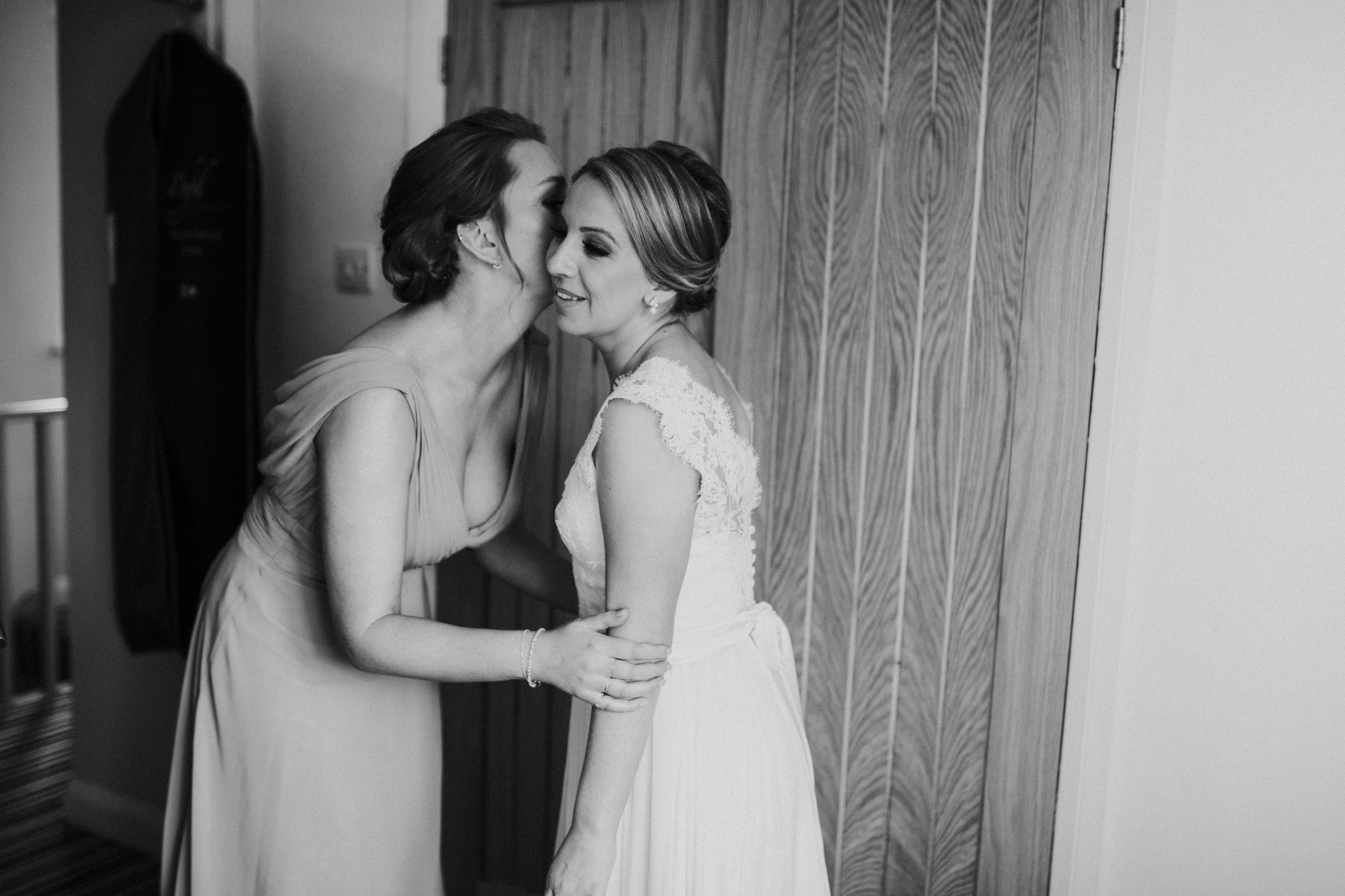 bridesmaids kissing bride 