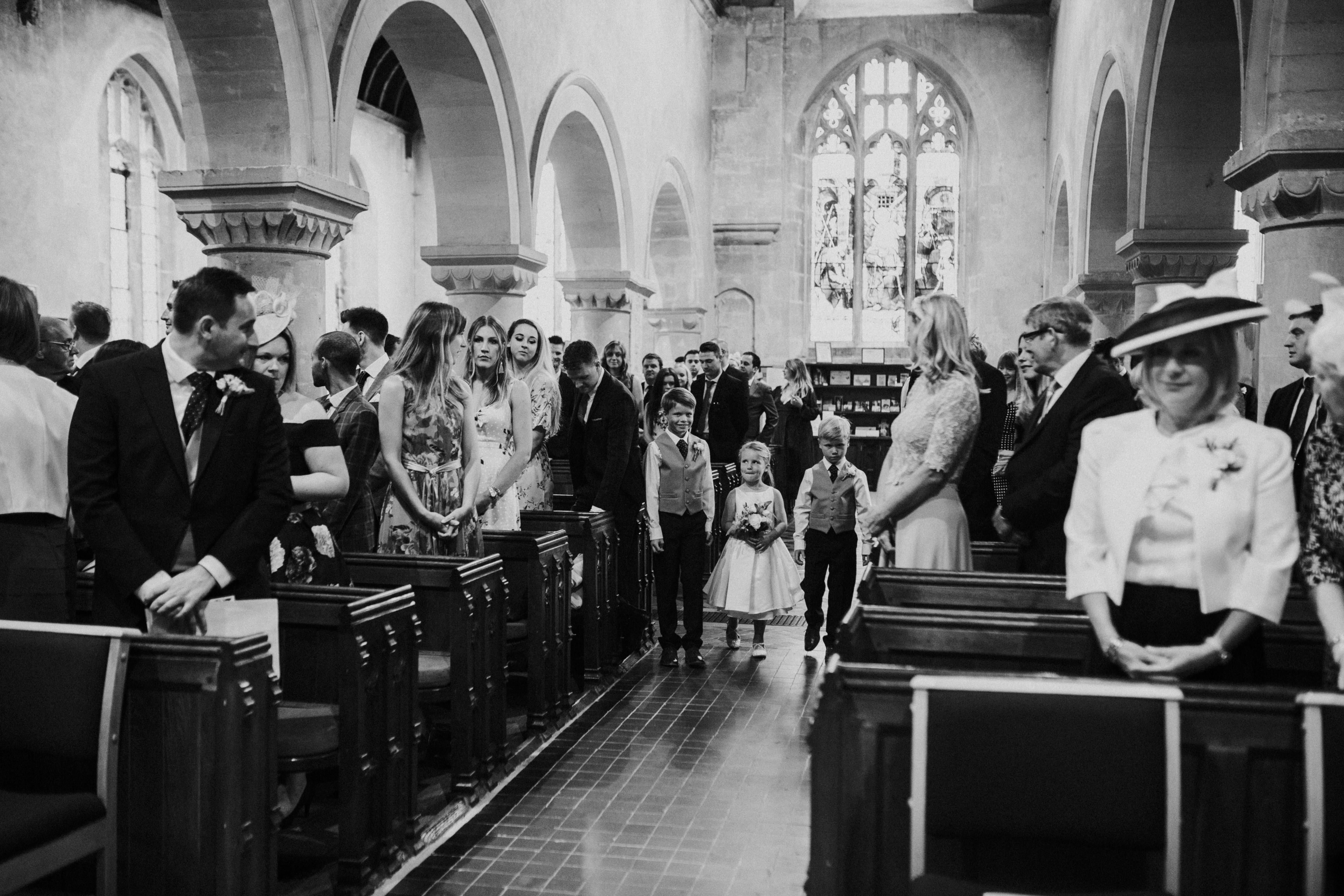 flower girl and Page boys walk down the aisle 