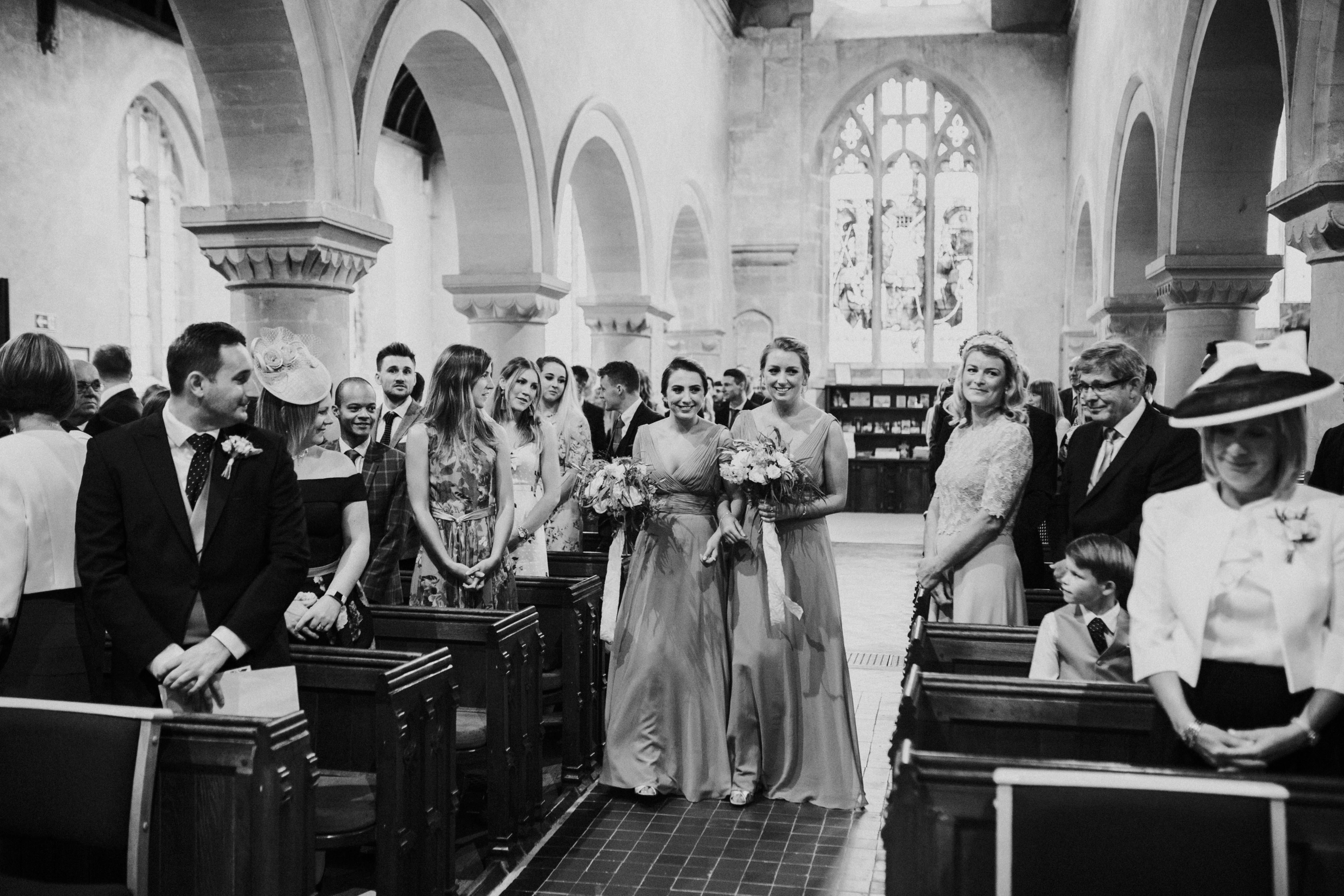 bridesmaids walking down the aisle 