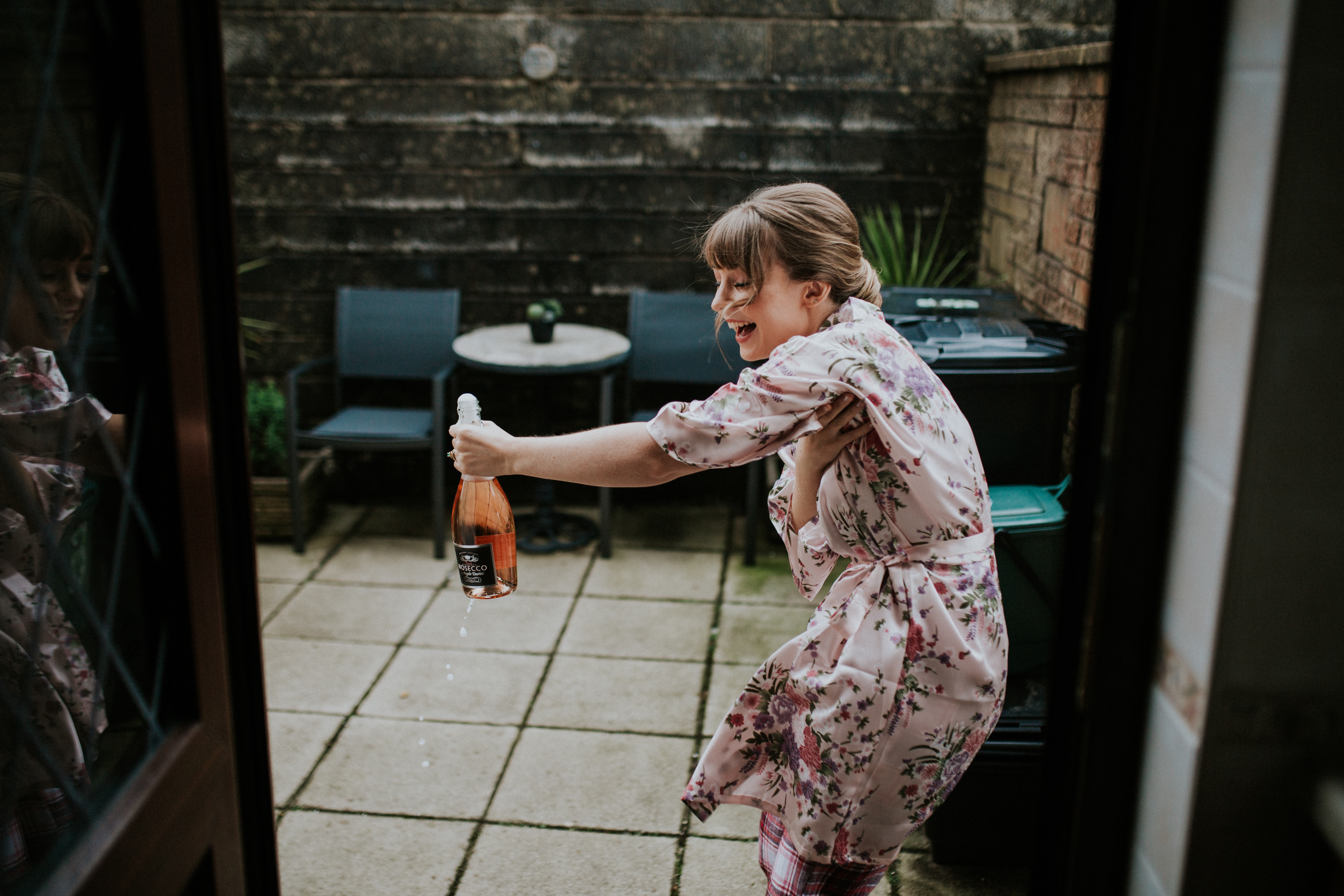 bridesmaid opening bottle 