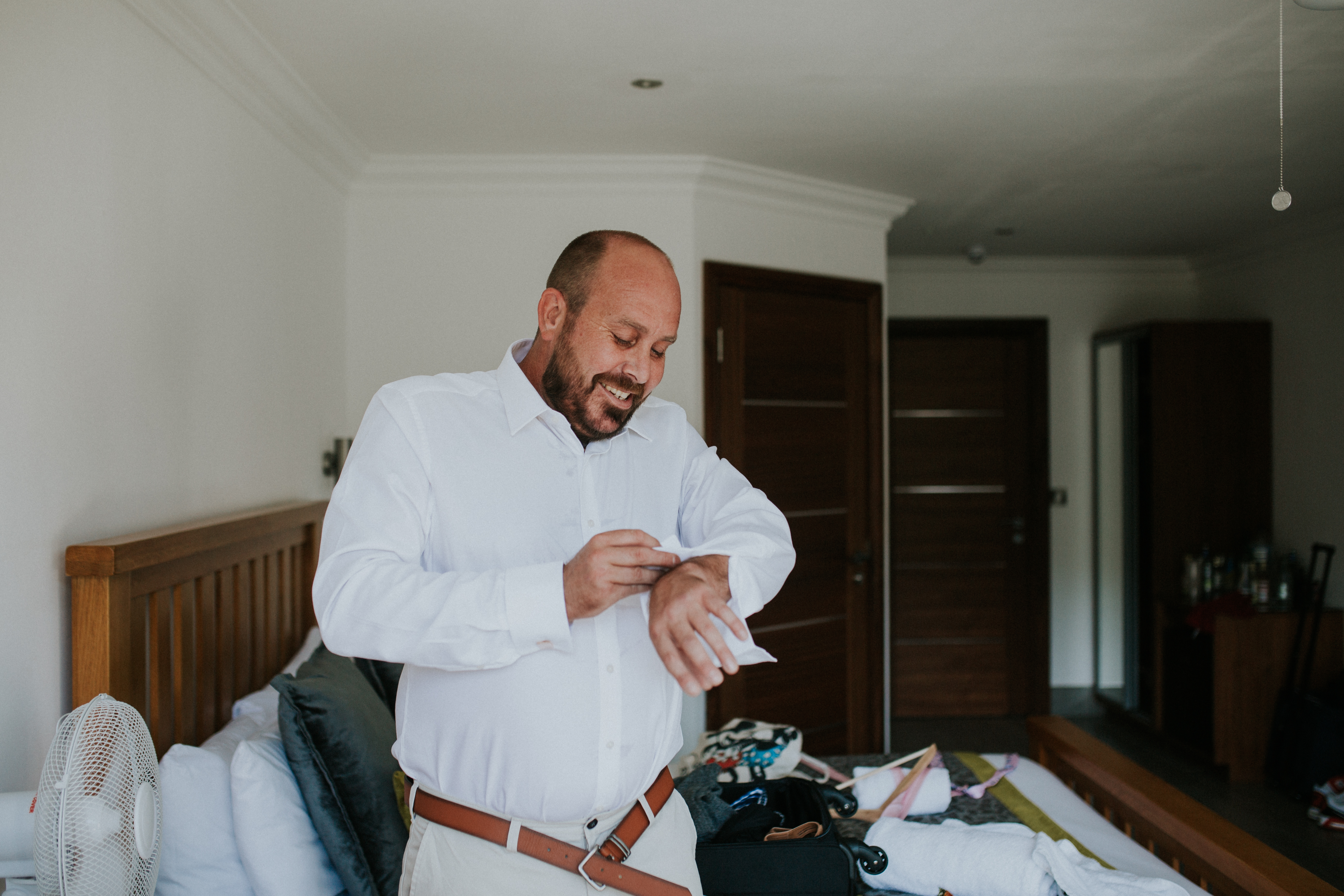 groom doing cufflinks