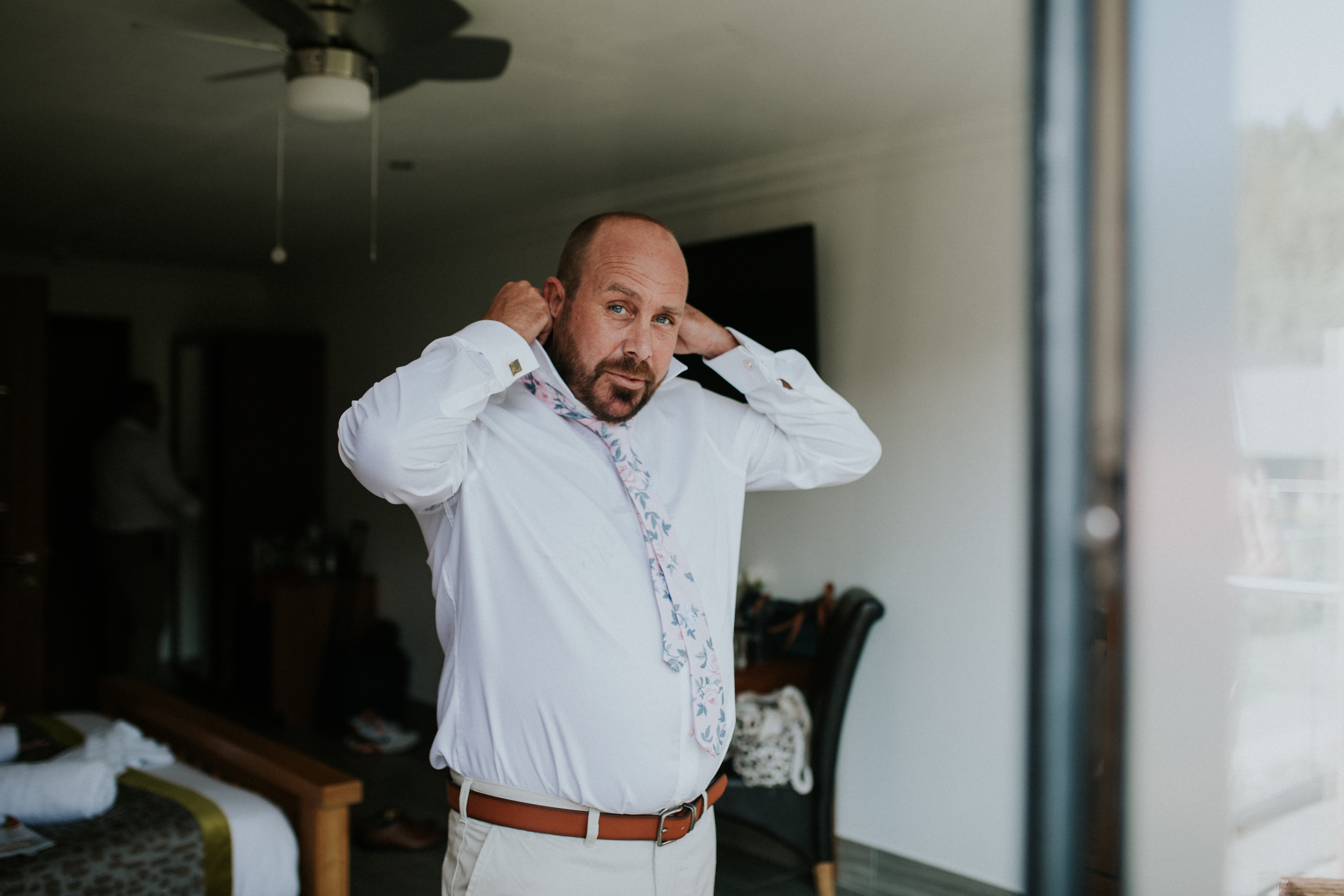 groom doing his tie