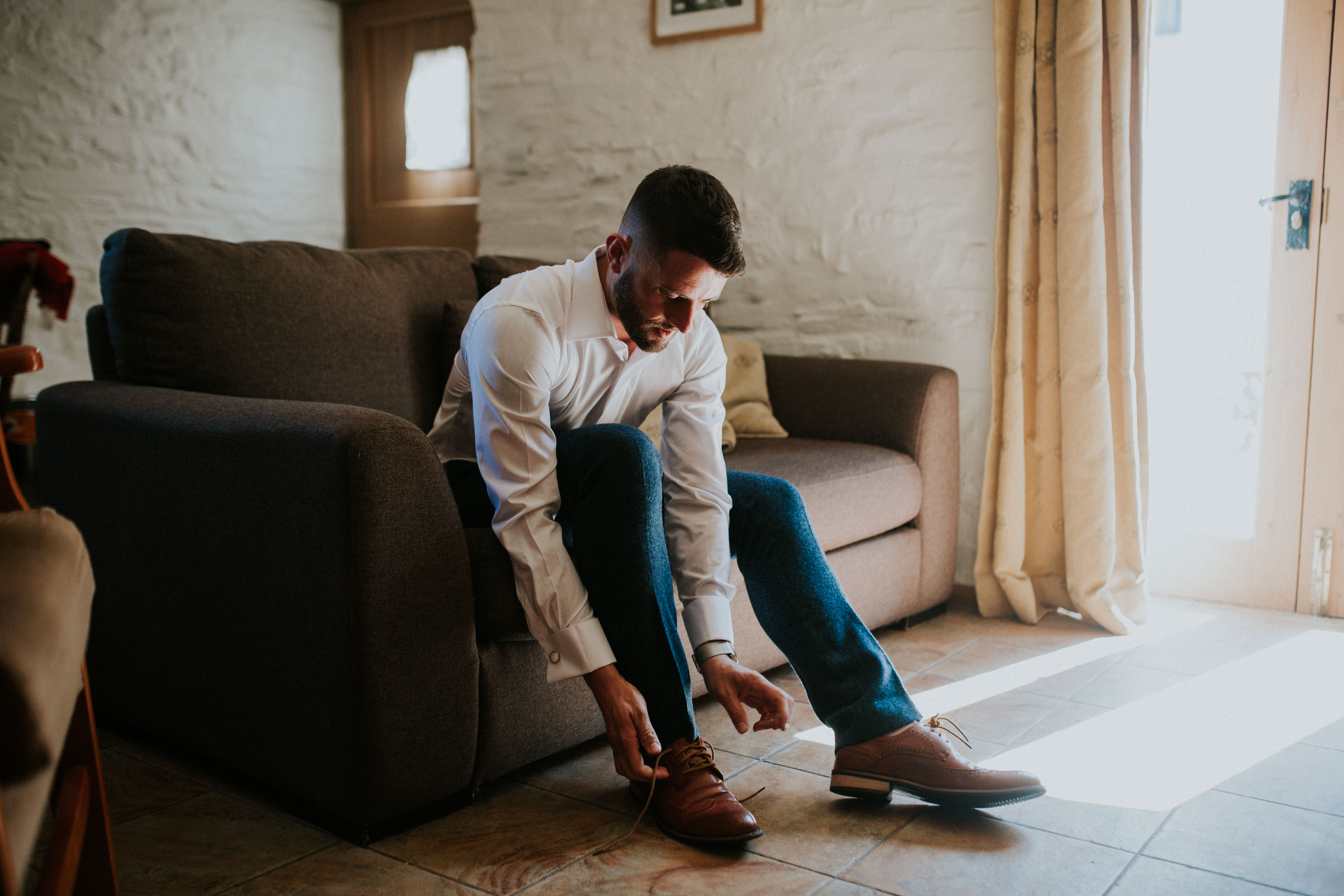 groom putting shoes on 