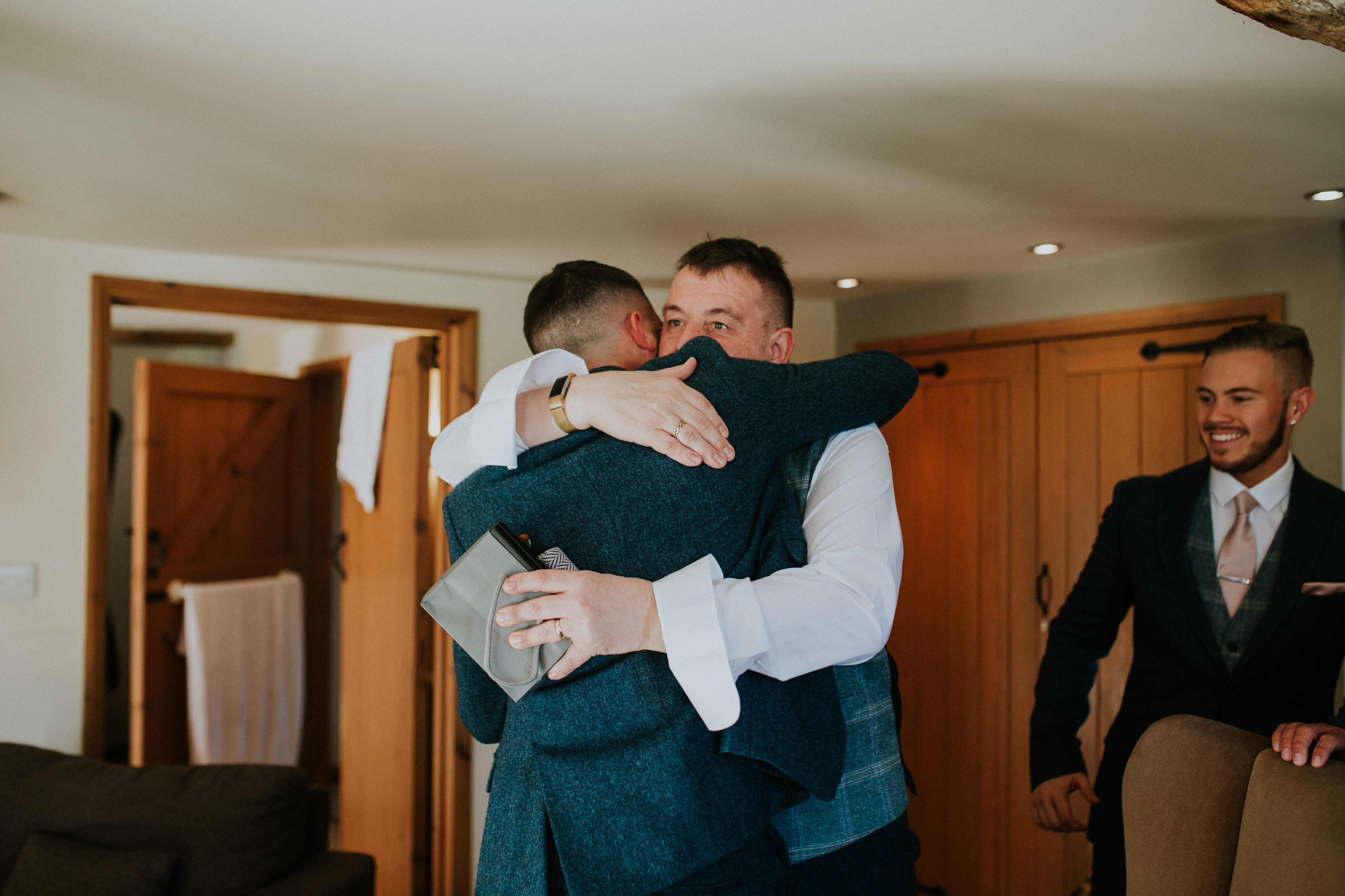 groomsmen hugging 