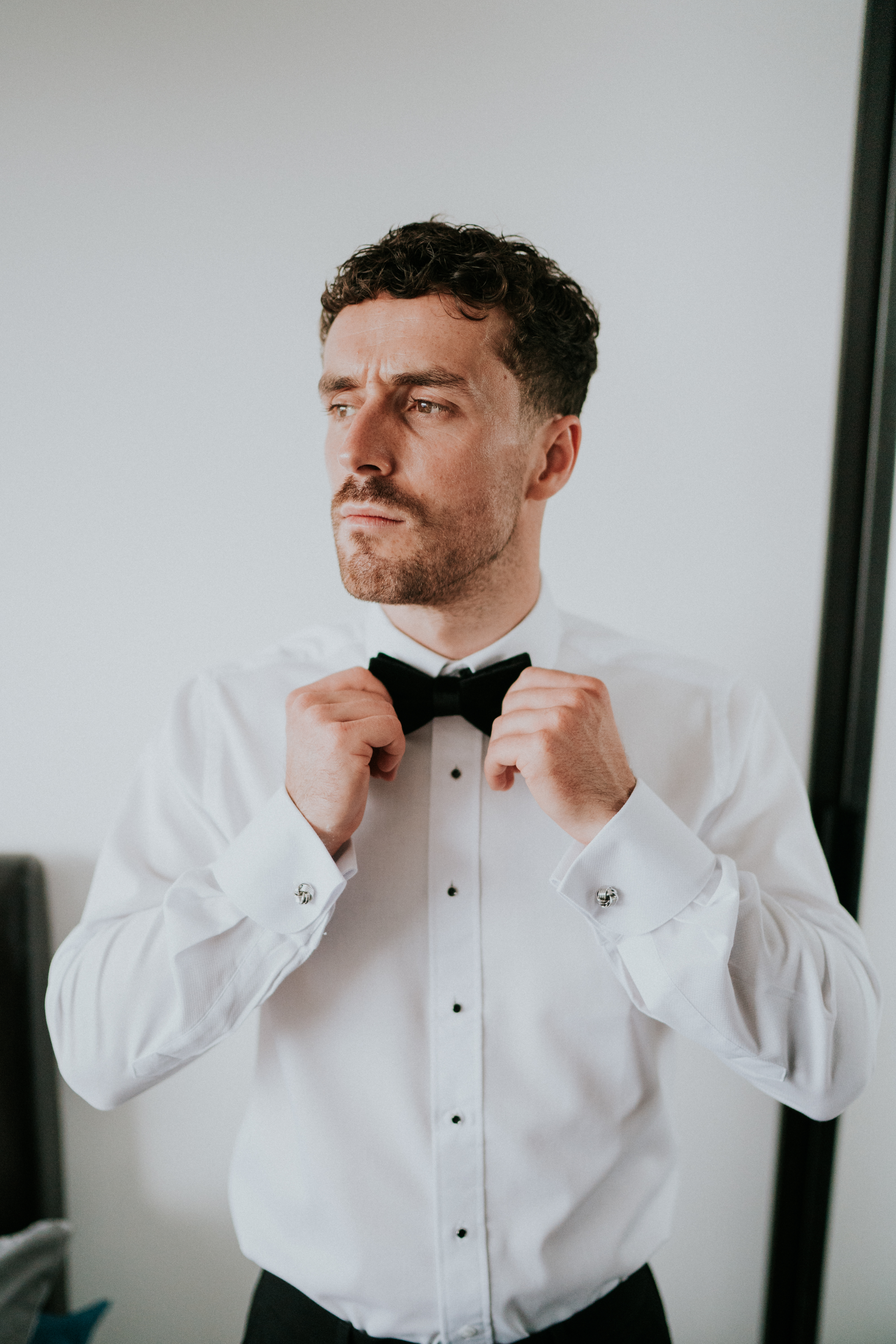 groom straightening tie 