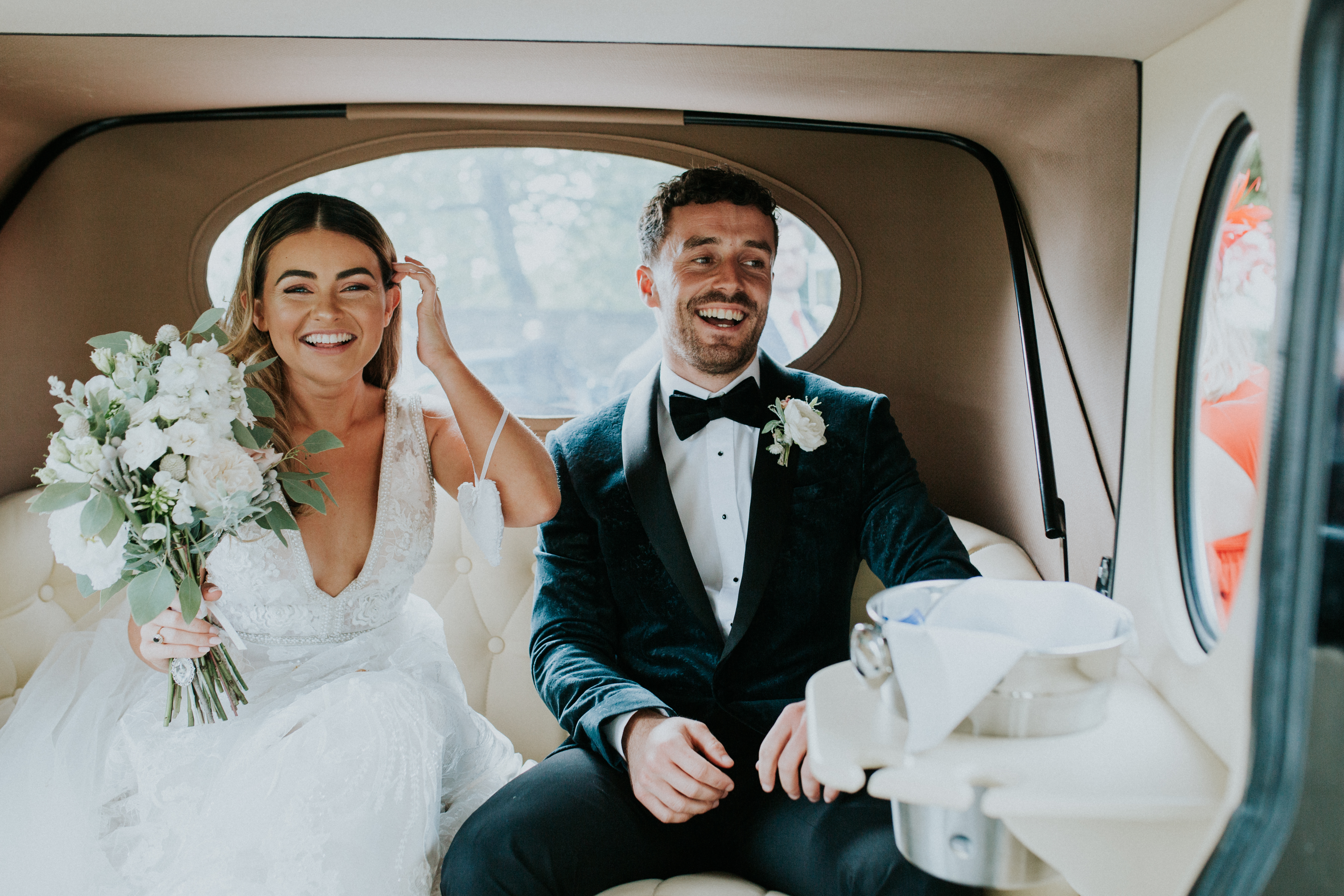 bride and groom in the wedding car 