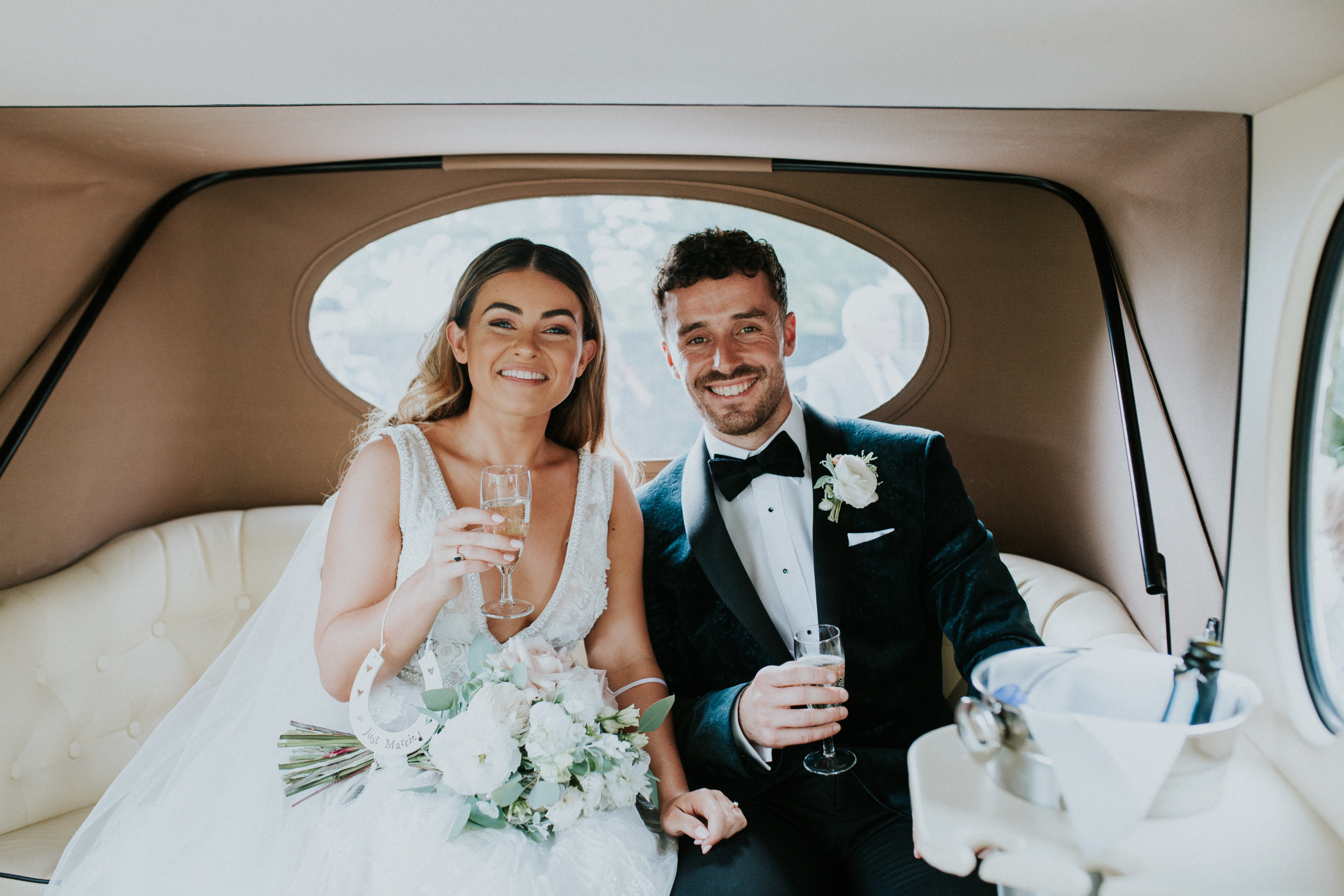 bride ask groom in the wedding car 