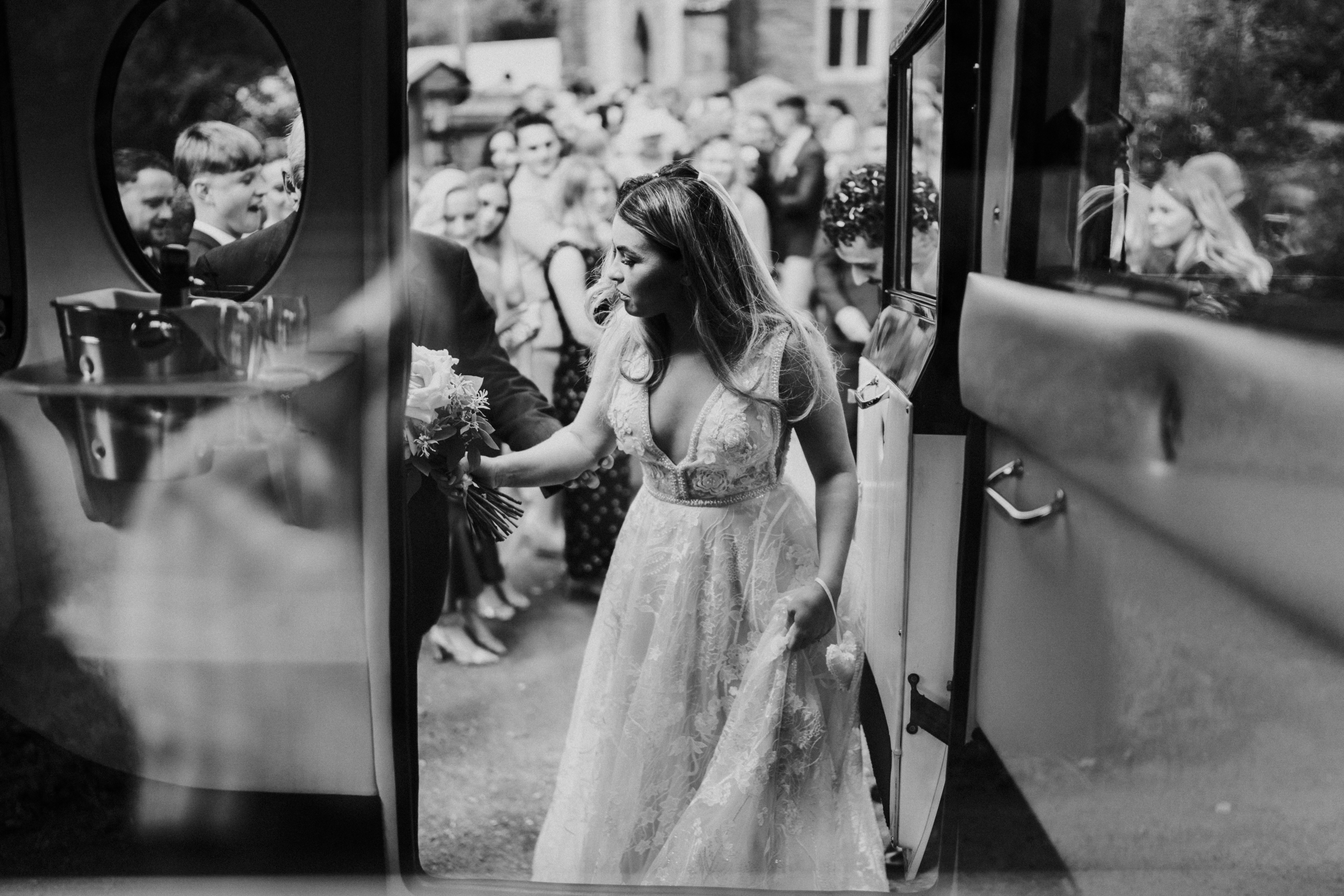 bride stepping into the wedding car 
